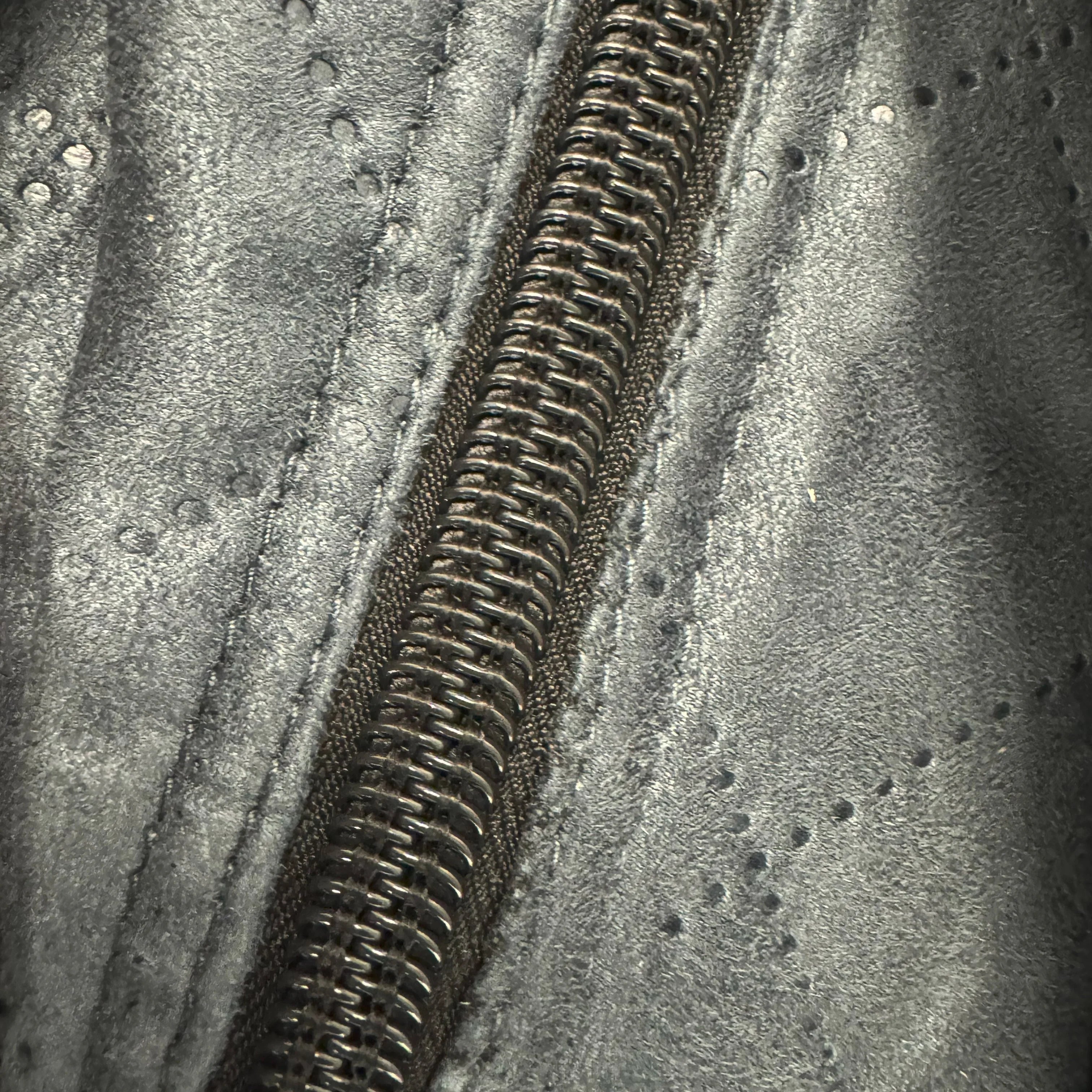 Close-up of metal zipper on silver quilted thermal liner for overland canopy