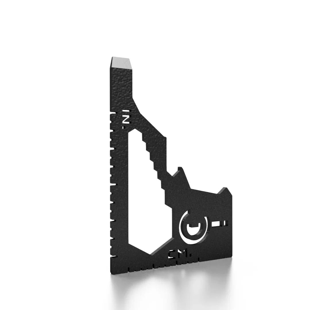 Black metal multi-tool with inch and centimeter measurement markings on white background