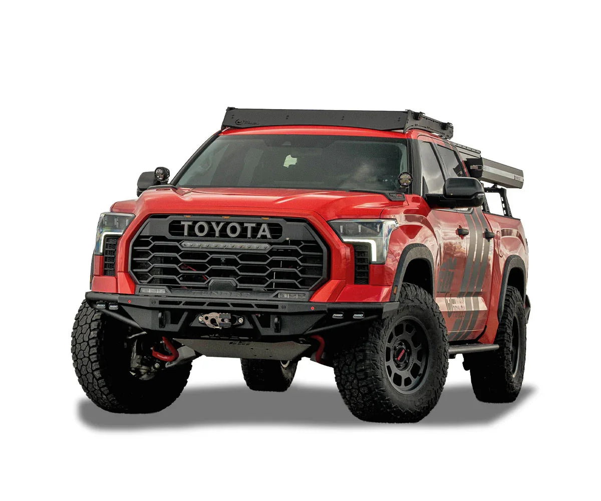 Red Toyota Tundra outfitted with off-road overlanding accessories and rugged tires