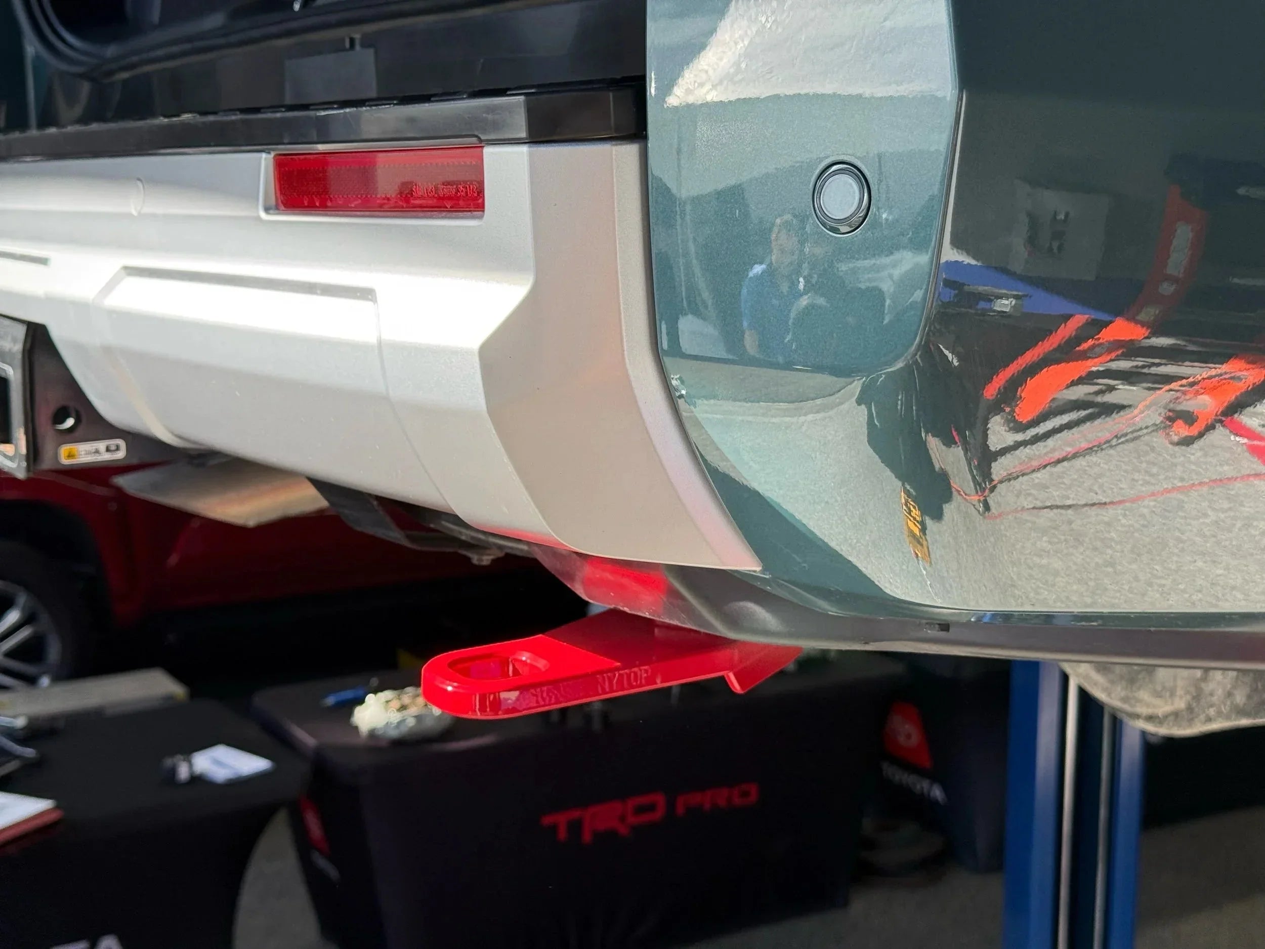 Toyota truck rear recovery point in red installed on bumper at outdoor event