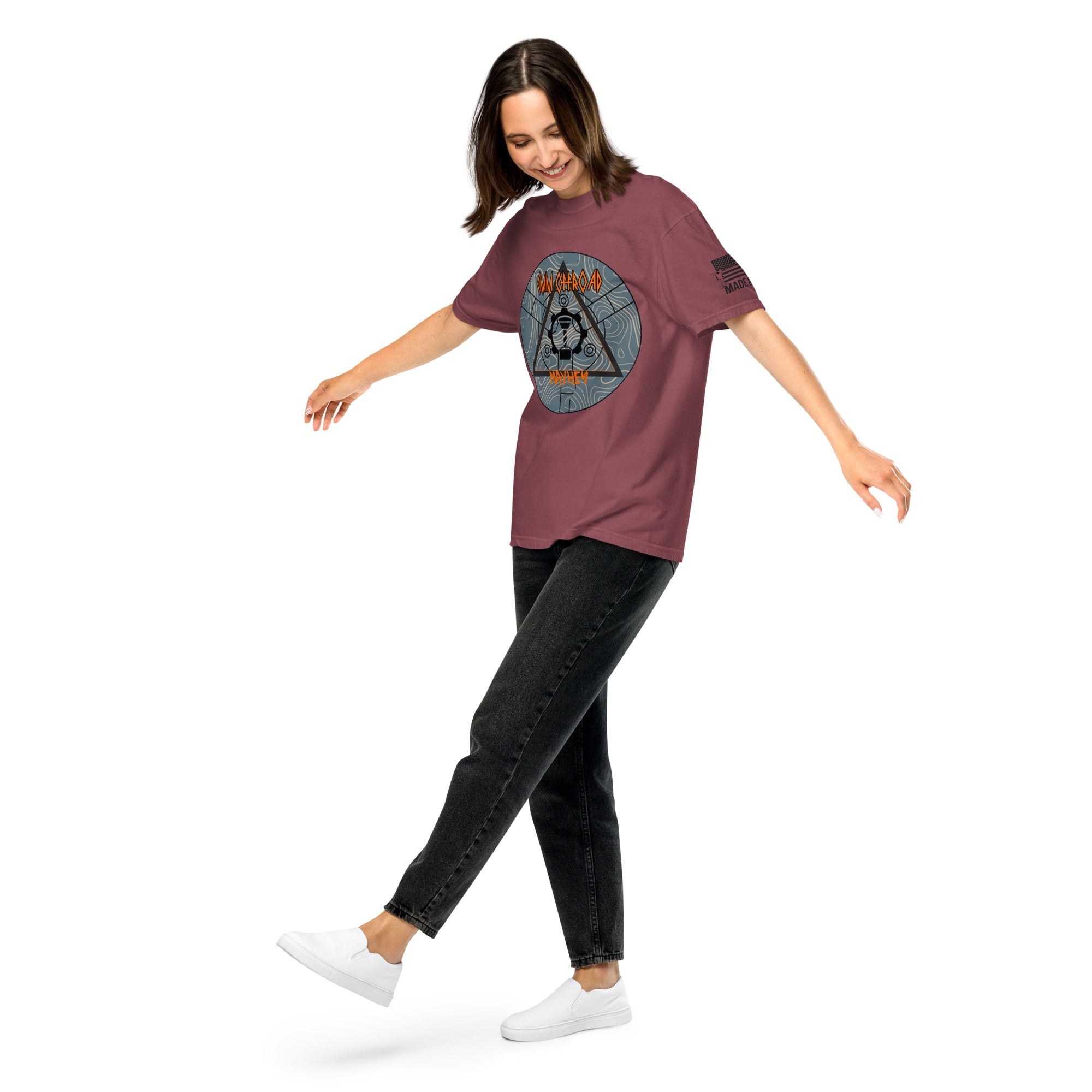 Unisex brick-colored heavyweight t-shirt with bold graphic design, worn by woman in casual pose