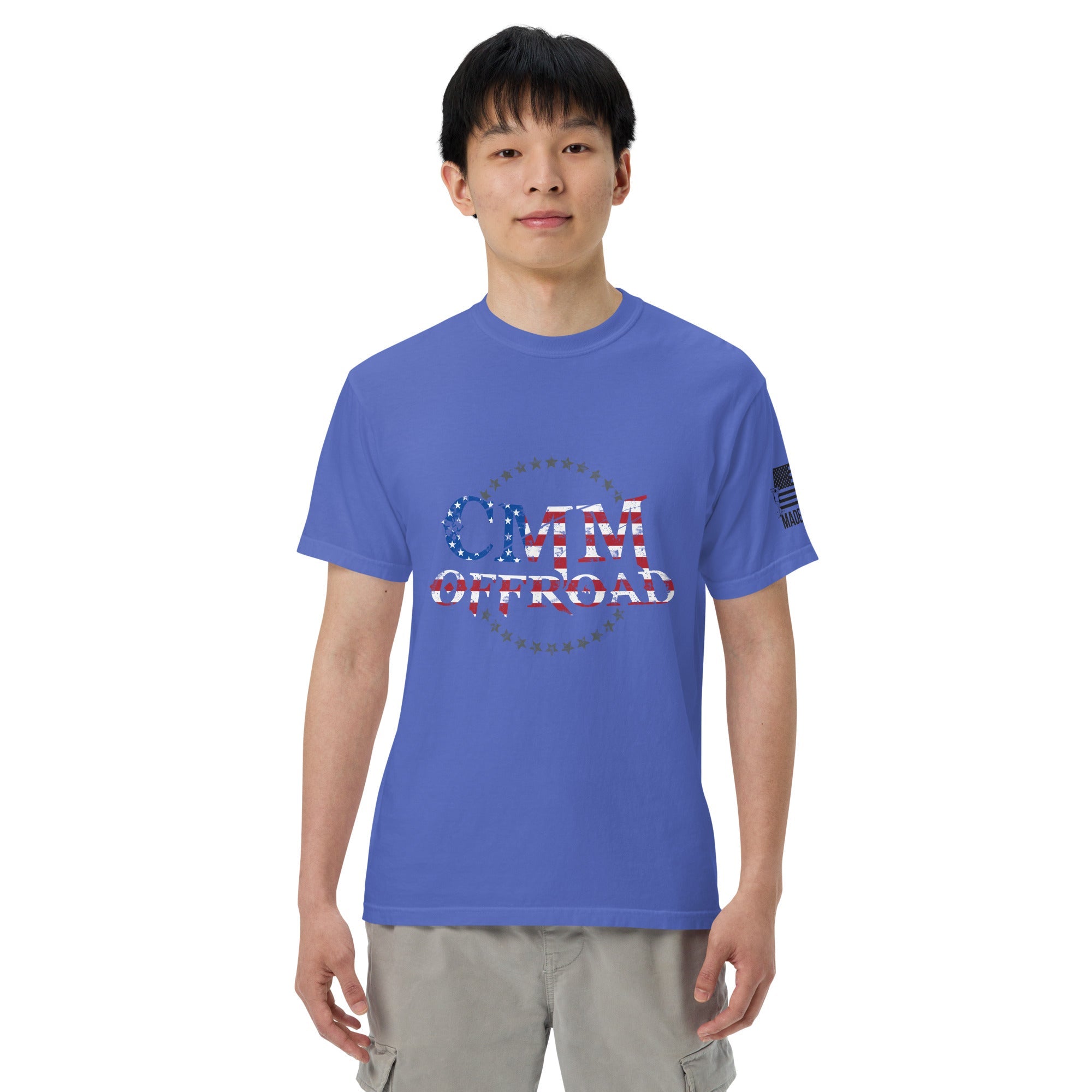 Man wearing a flo blue heavy cotton t-shirt with CMM Offroad American flag logo and cargo shorts