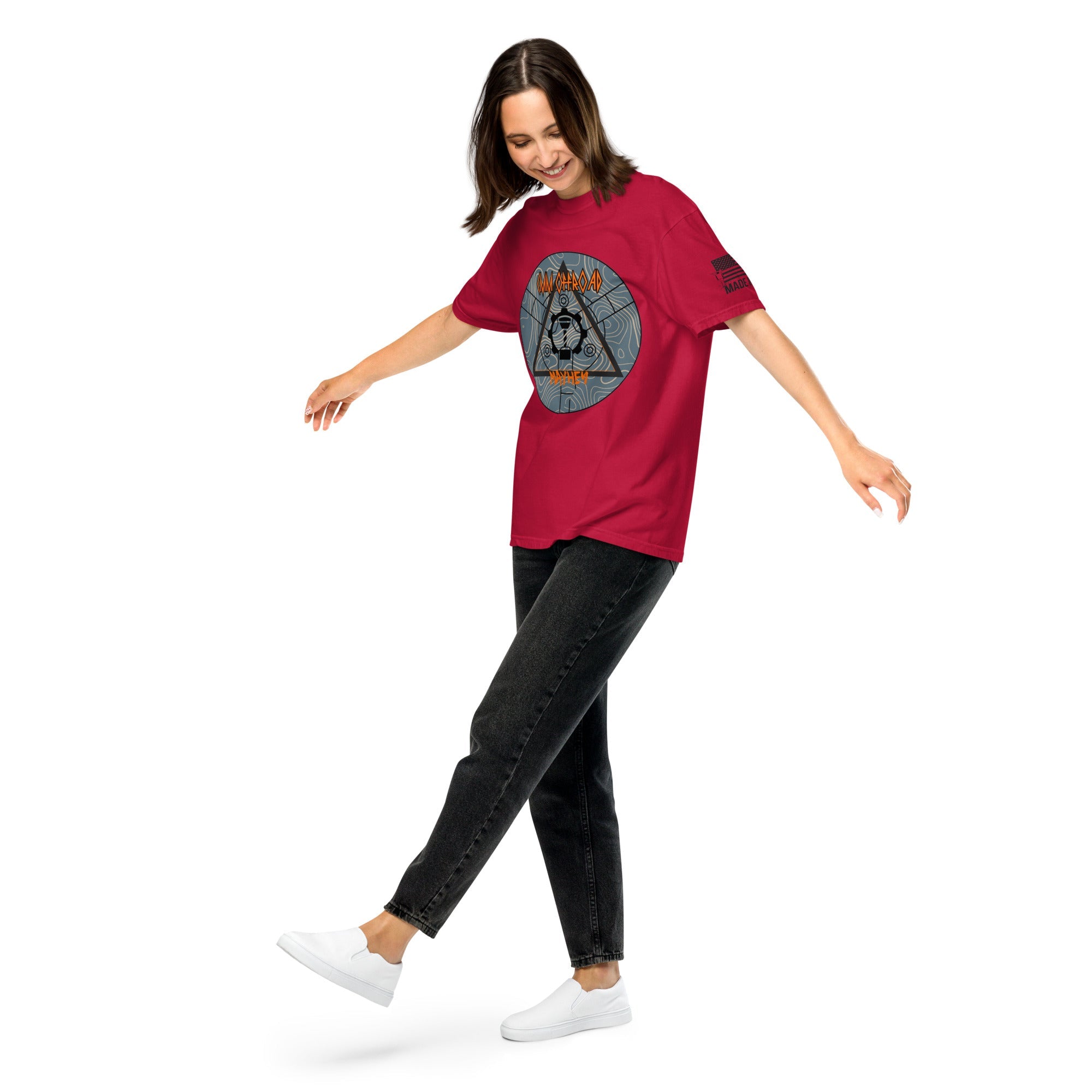 Woman wearing a red unisex heavyweight graphic t-shirt, casual black jeans, white shoes