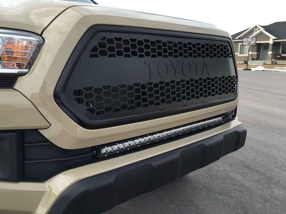 Front grill with honeycomb design and LED light bar on Toyota Tacoma