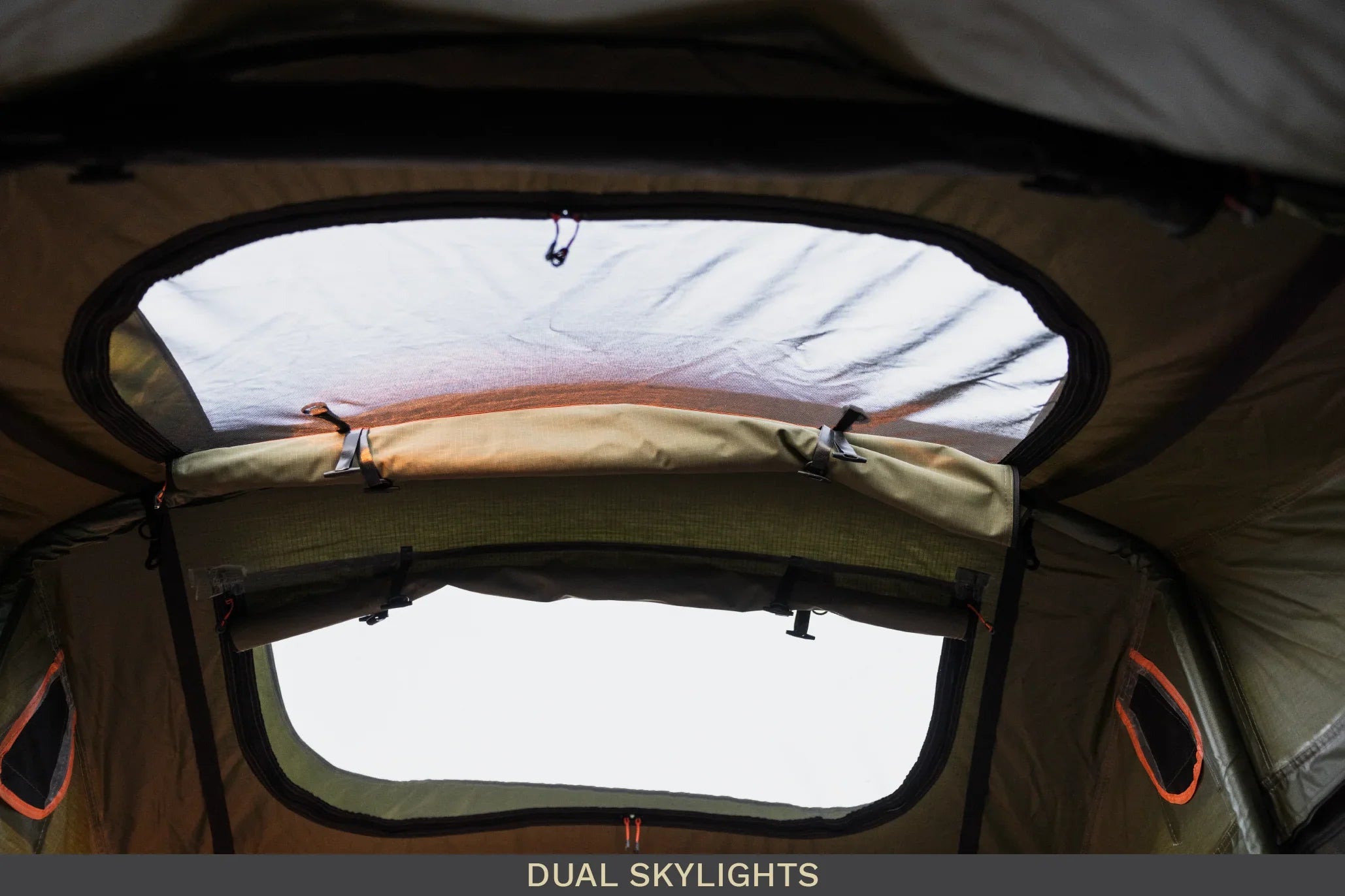 Interior view of camping tent with dual skylights and mesh windows for overlanding gear