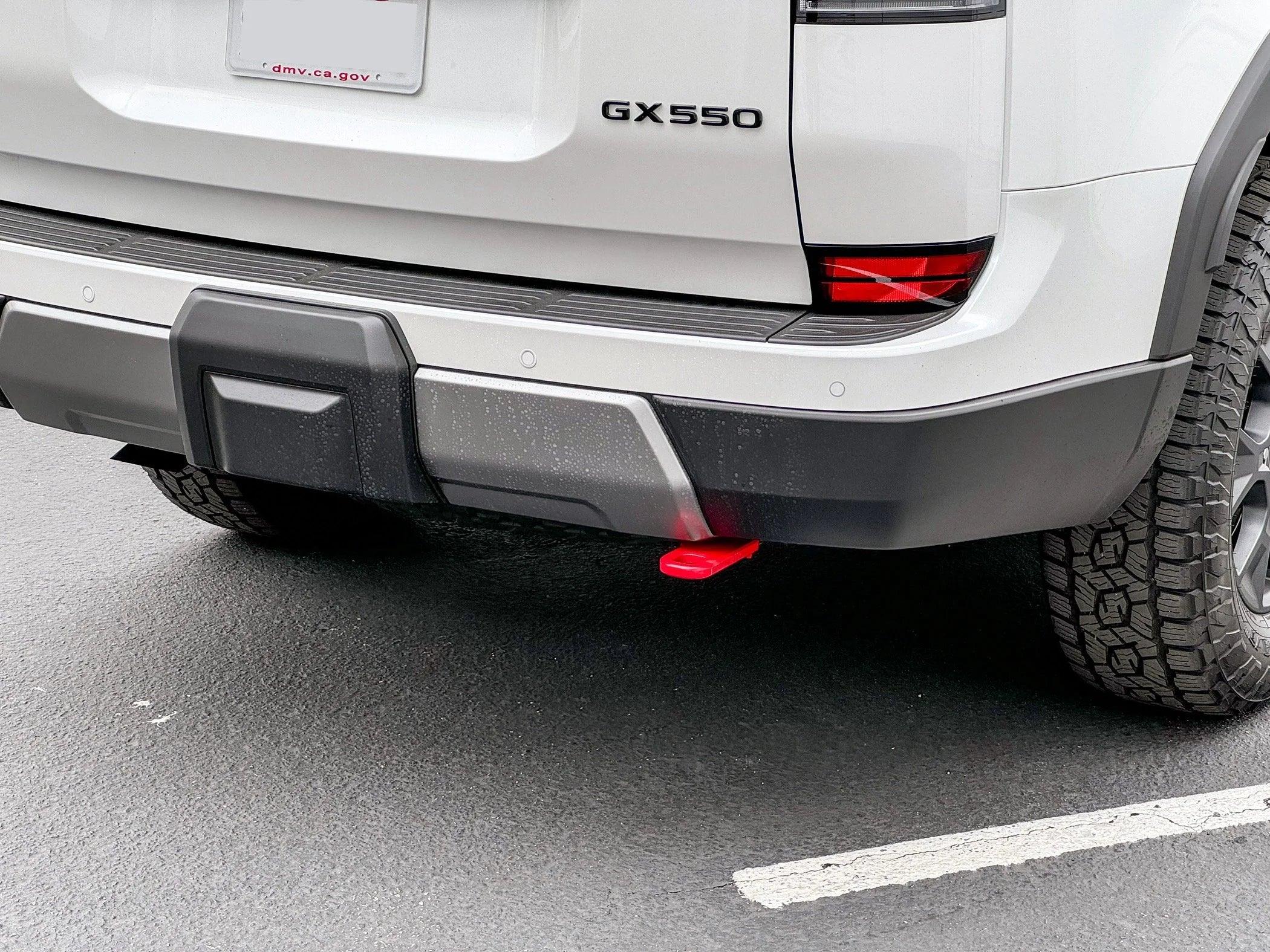 Rear view of Lexus GX550 with off-road bumper, red recovery point, and all-terrain tire