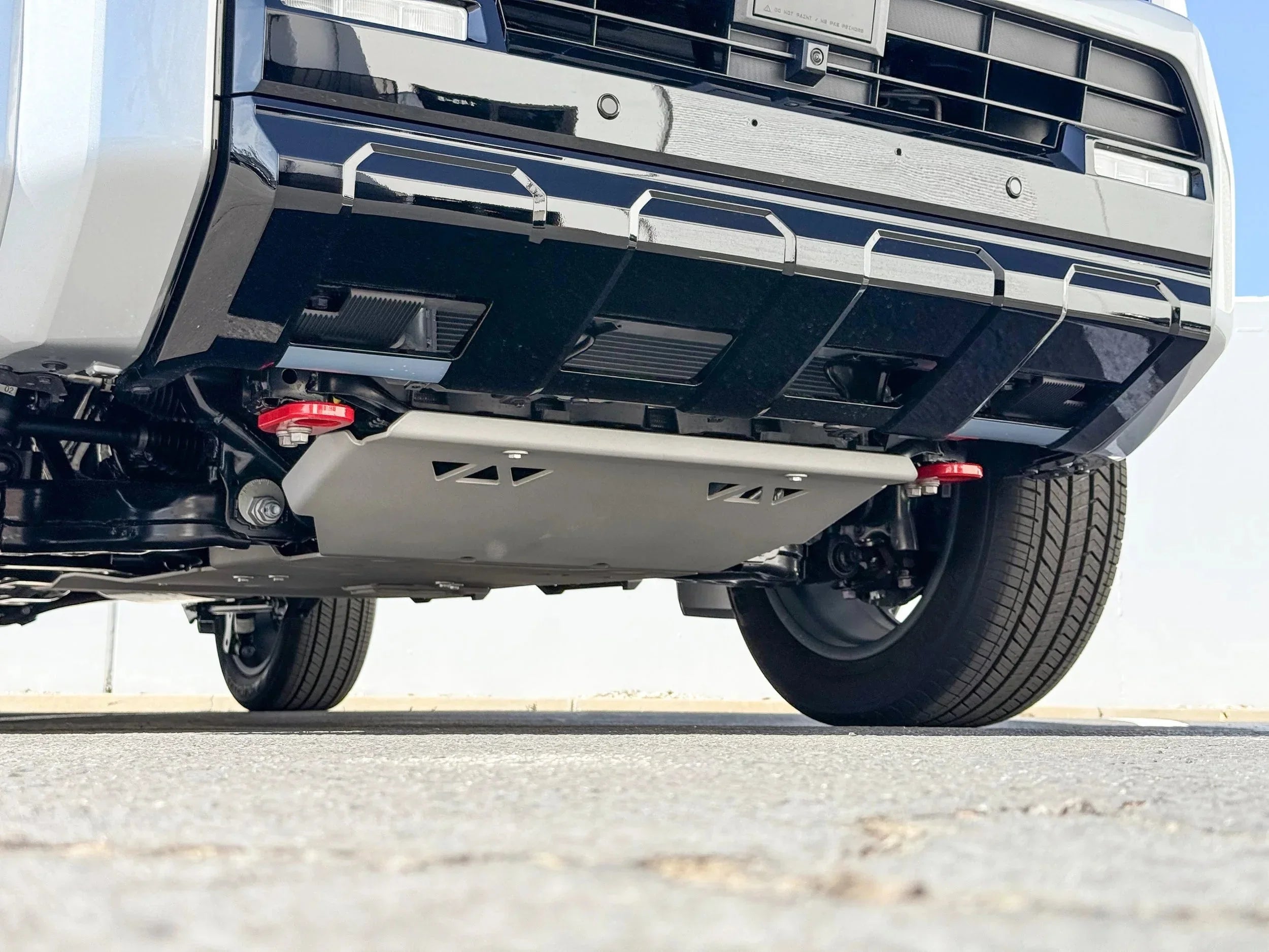 Underbody view of a truck with aftermarket skid plate and off-road accessories installed