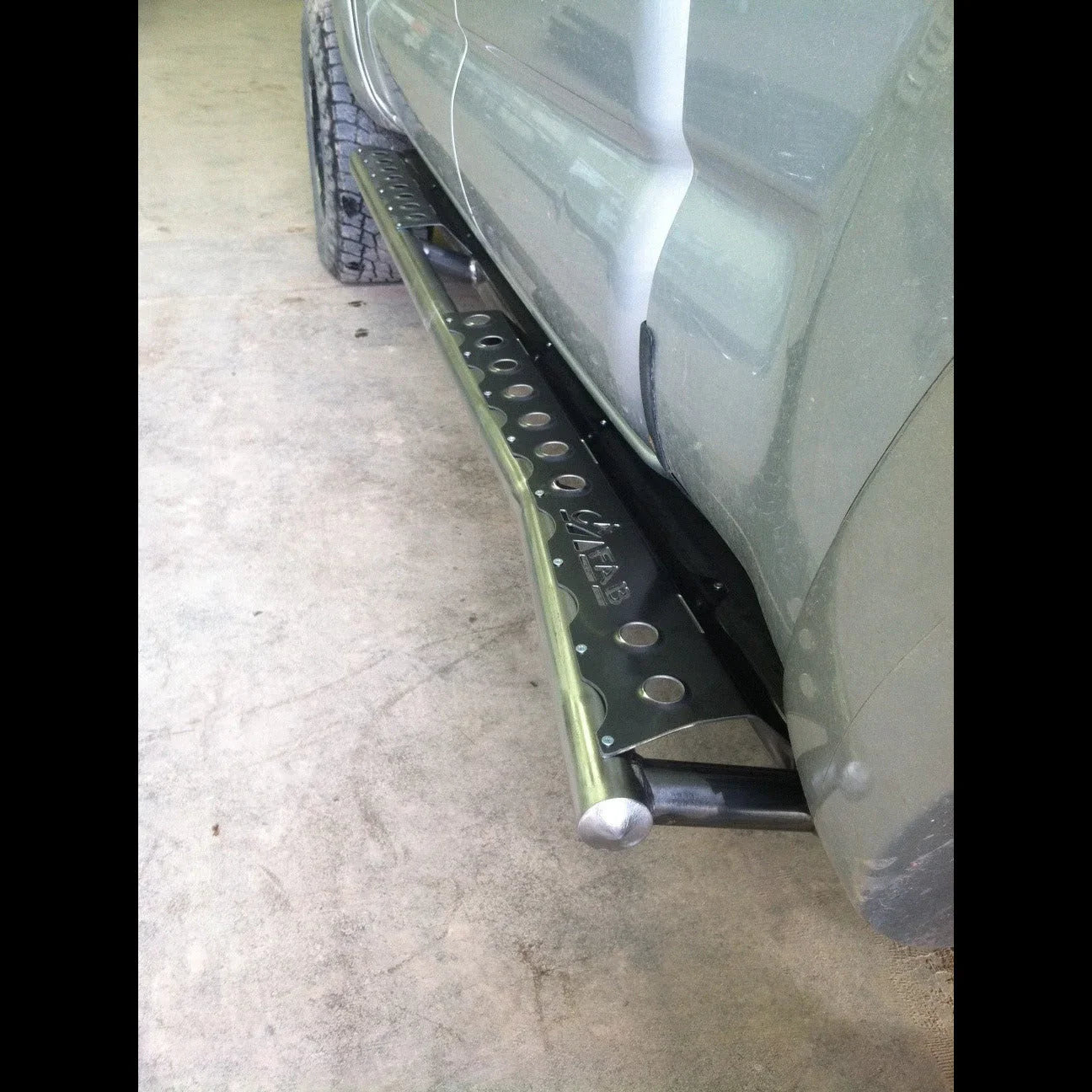 Heavy-duty rock slider mounted on Toyota Tacoma for off-road protection
