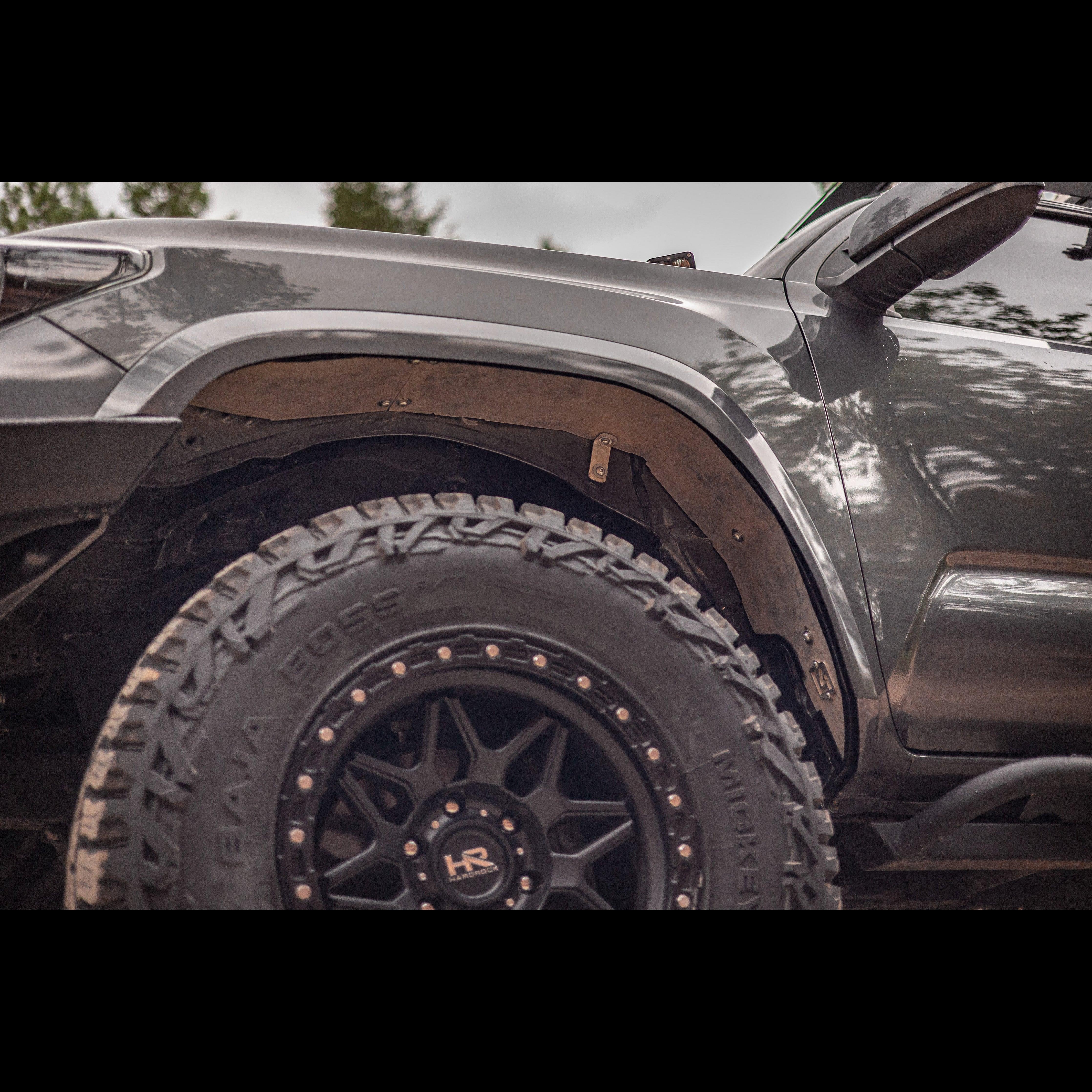 Toyota Tacoma closeup with aftermarket fender liner and off-road tire