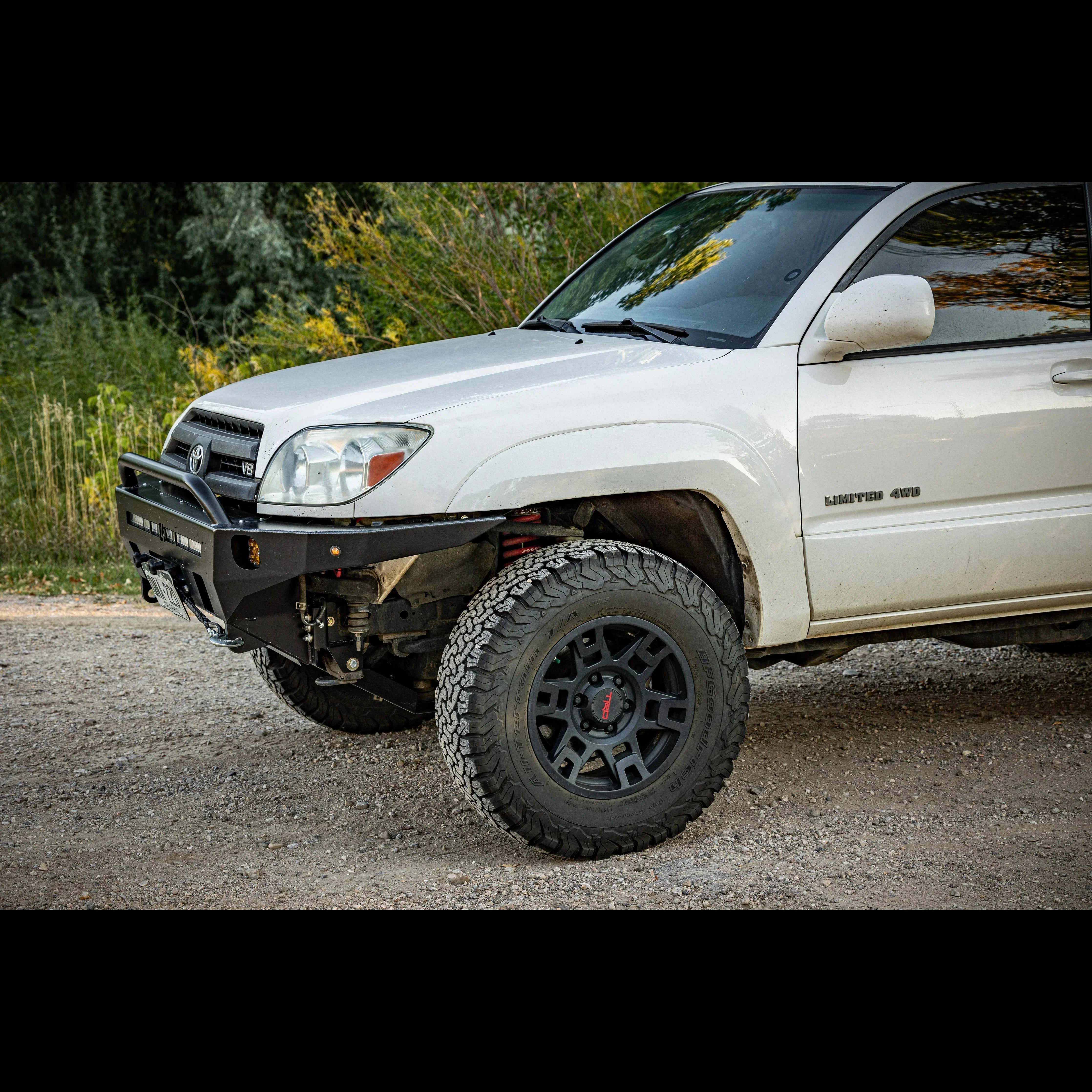 Toyota 4Runner Limited 4WD with off-road bumper, all-terrain tires, outdoor setting