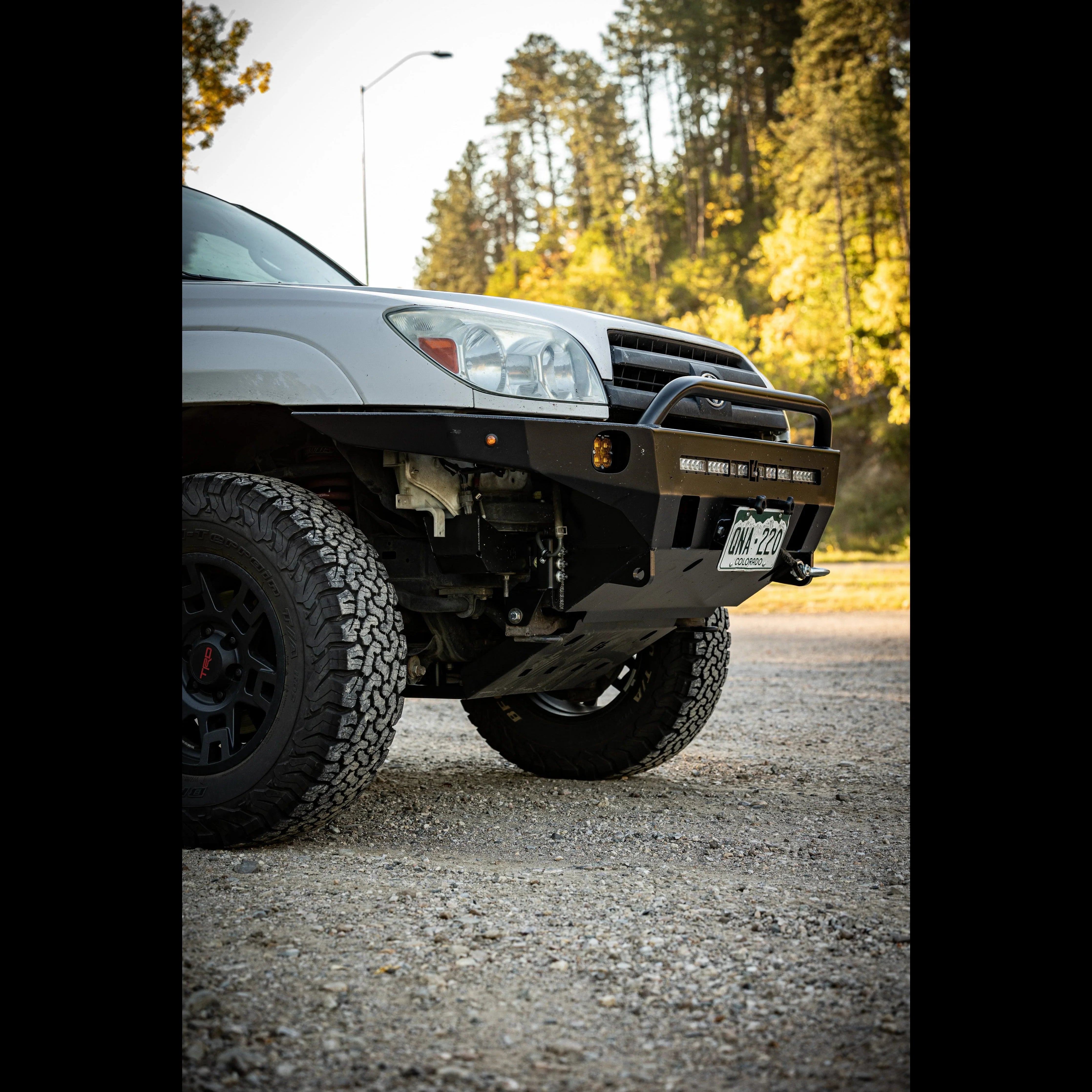 Toyota 4Runner with off-road front bumper and rugged tires in outdoor setting