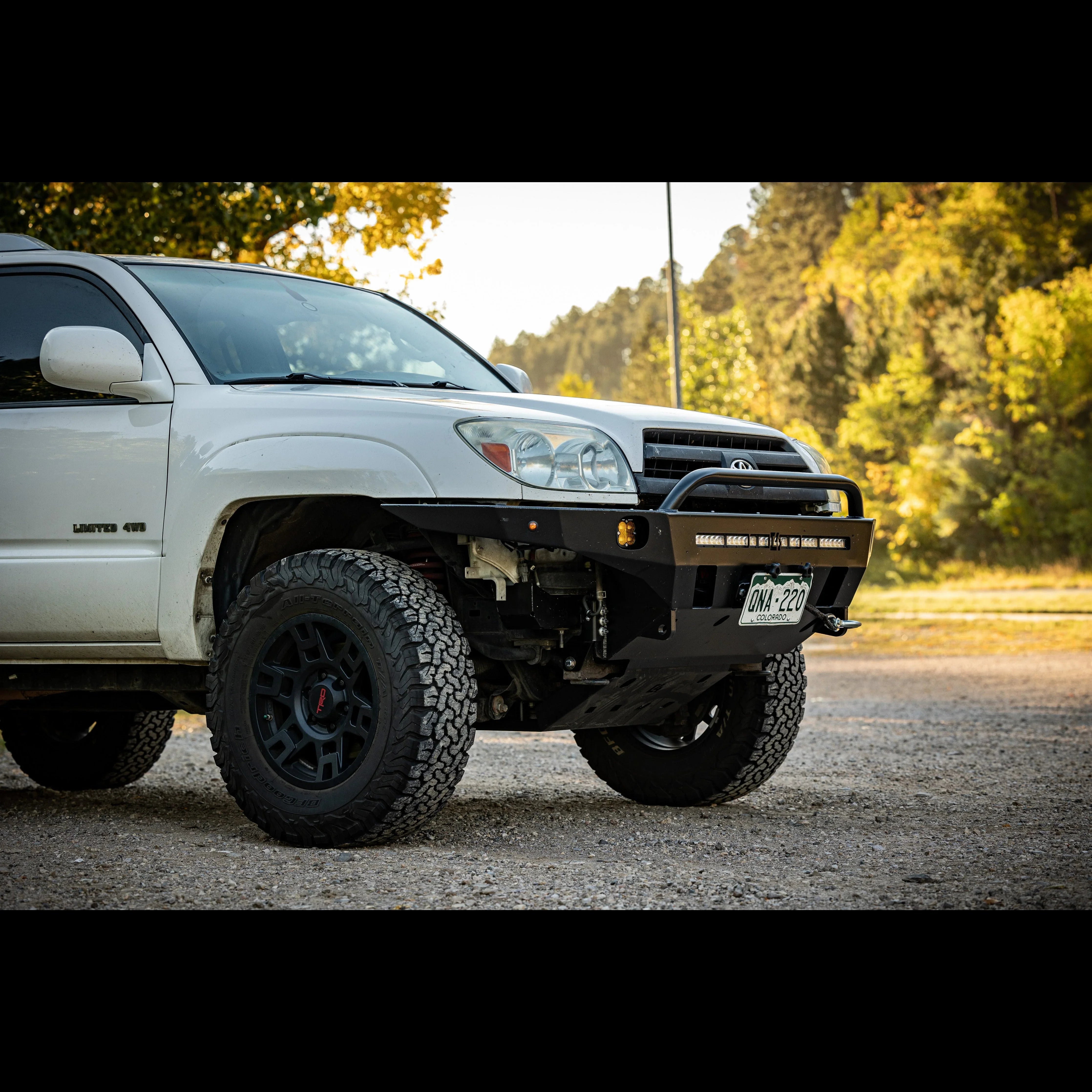 Toyota 4Runner with off-road front bumper, all-terrain tires, and lifted suspension outdoors