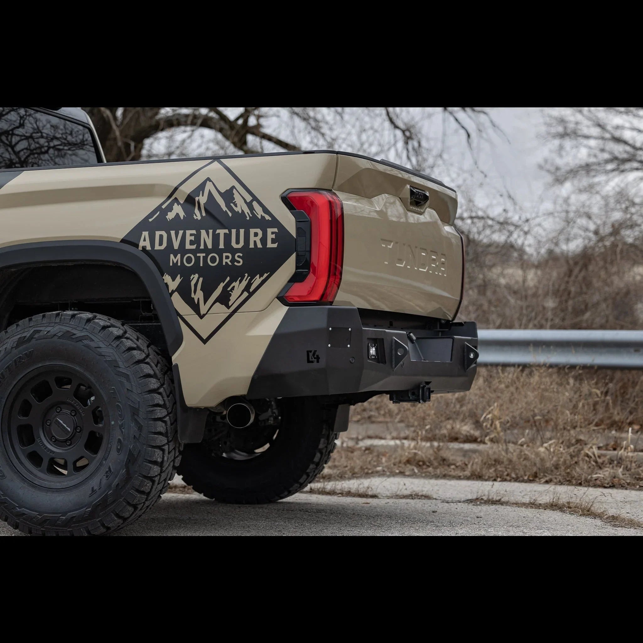 Toyota Tundra with custom off-road rear bumper and rugged tires, Adventure Motors decal