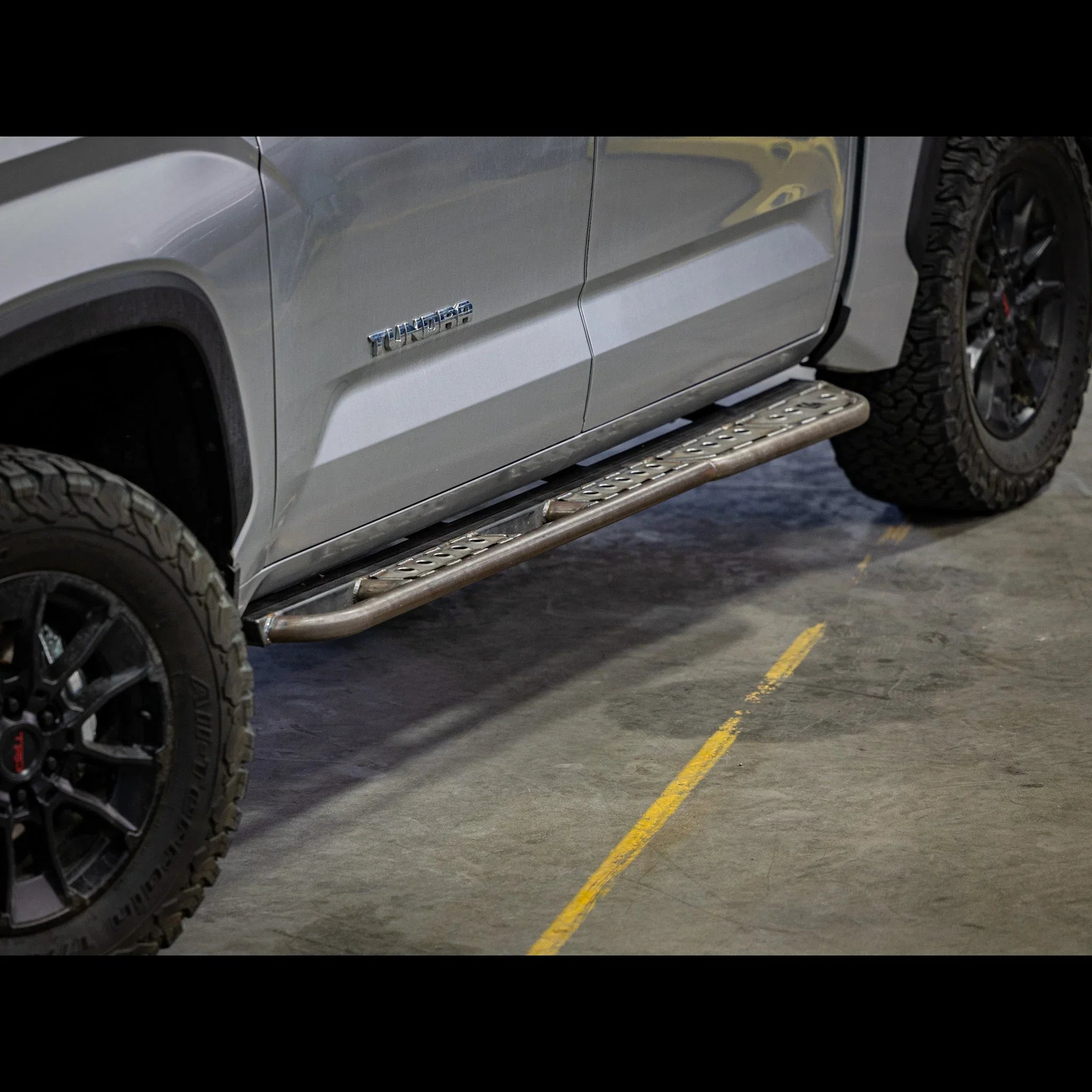 Rock slider step installed on Toyota Tundra side, off-road aftermarket accessory