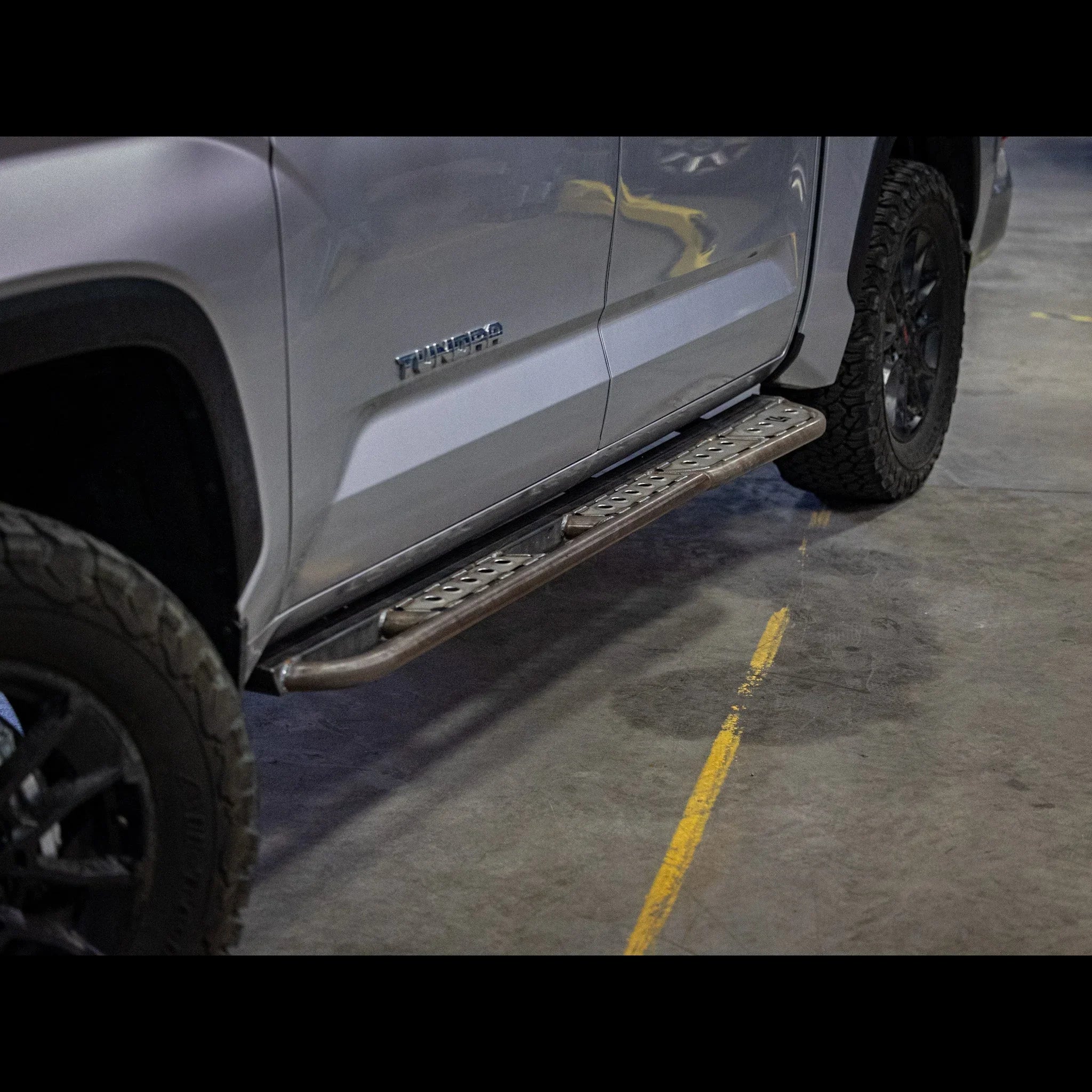 Steel rock slider step installed on Toyota Tundra truck for overlanding protection