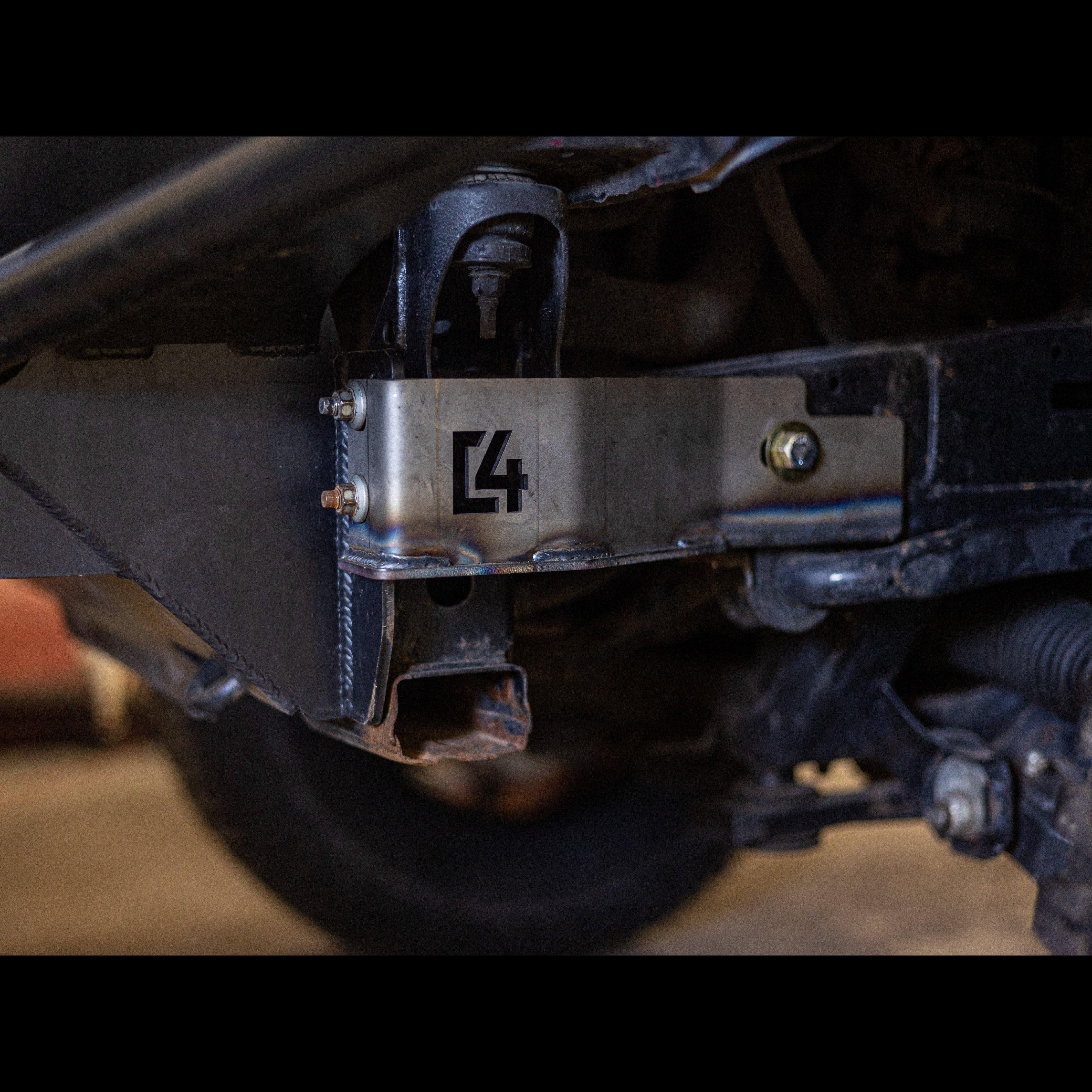 Steel aftermarket bumper bracket with bolts on off-road vehicle chassis, closeup view