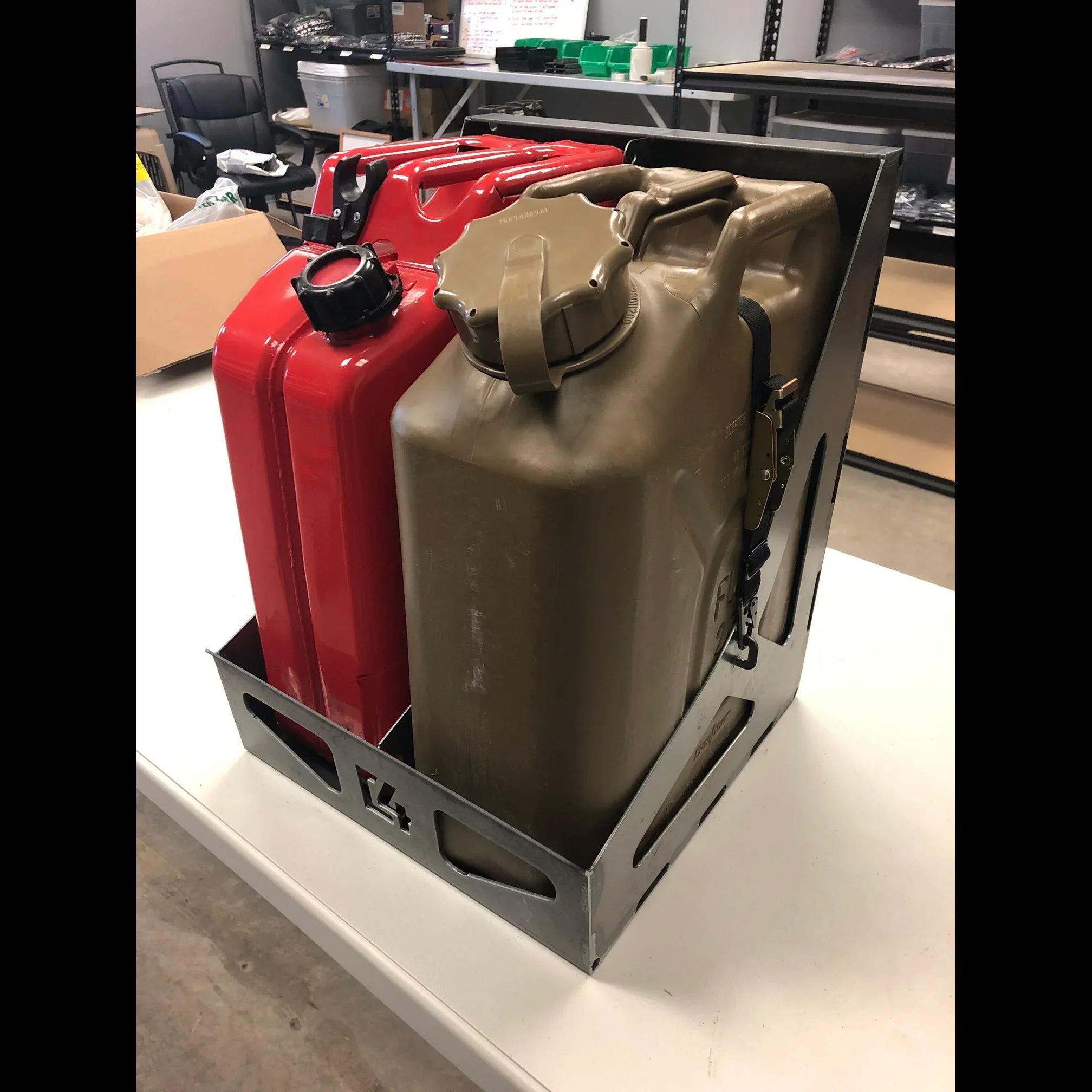 Metal jerry can holder securing red and tan fuel containers for overlanding vehicles
