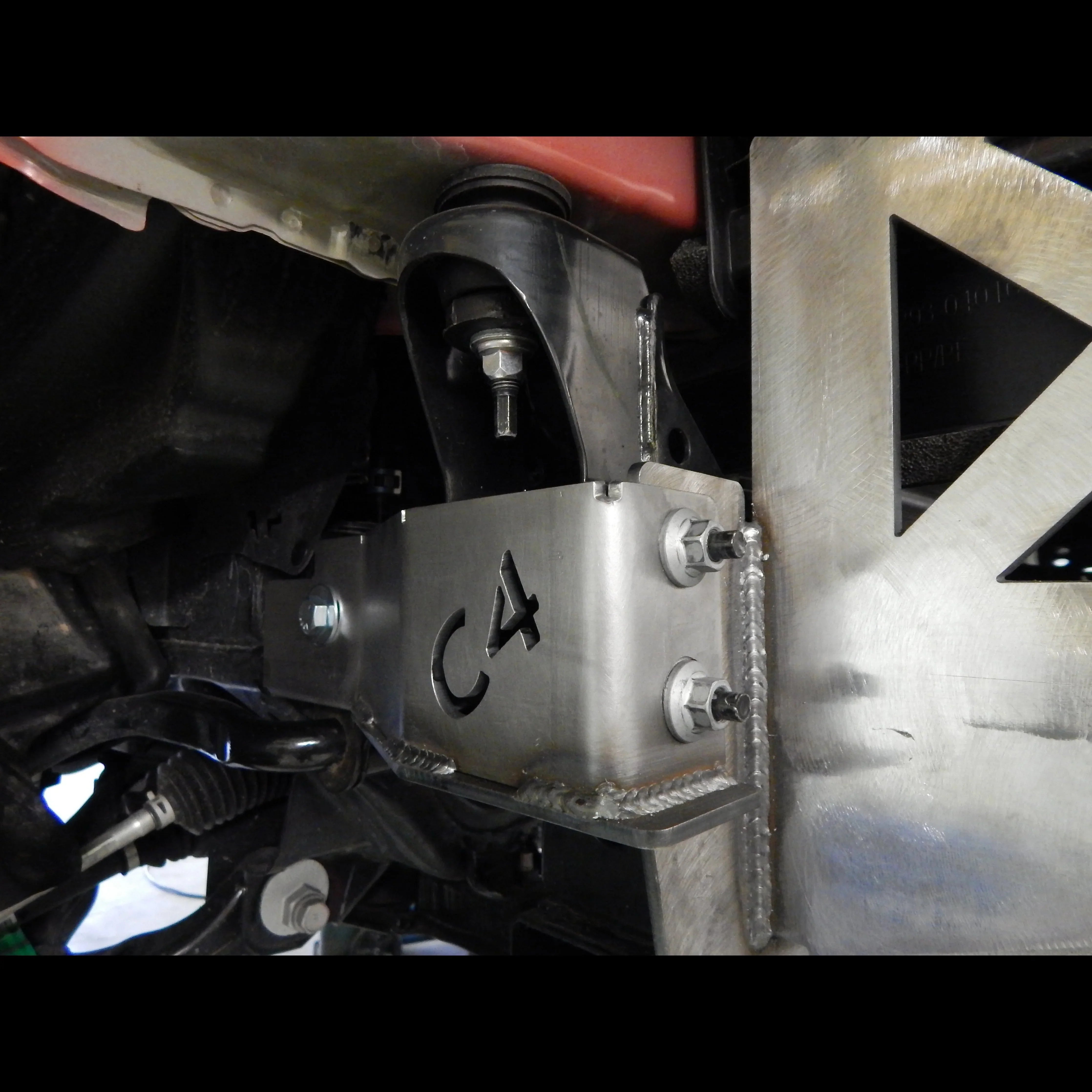Toyota Tacoma front bumper frame support brackets installed, close-up view