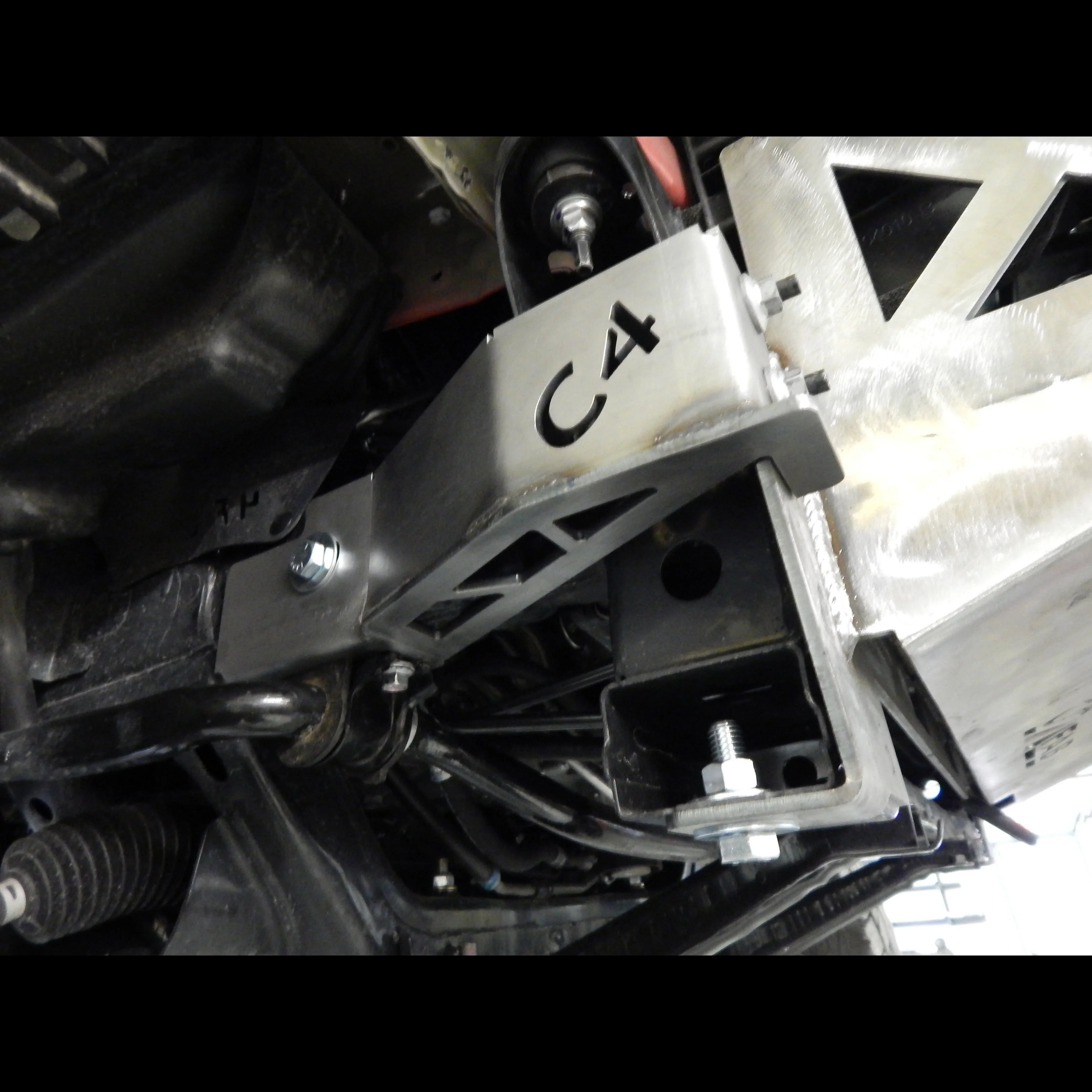 Steel front bumper frame support bracket installed on a Toyota Tacoma undercarriage