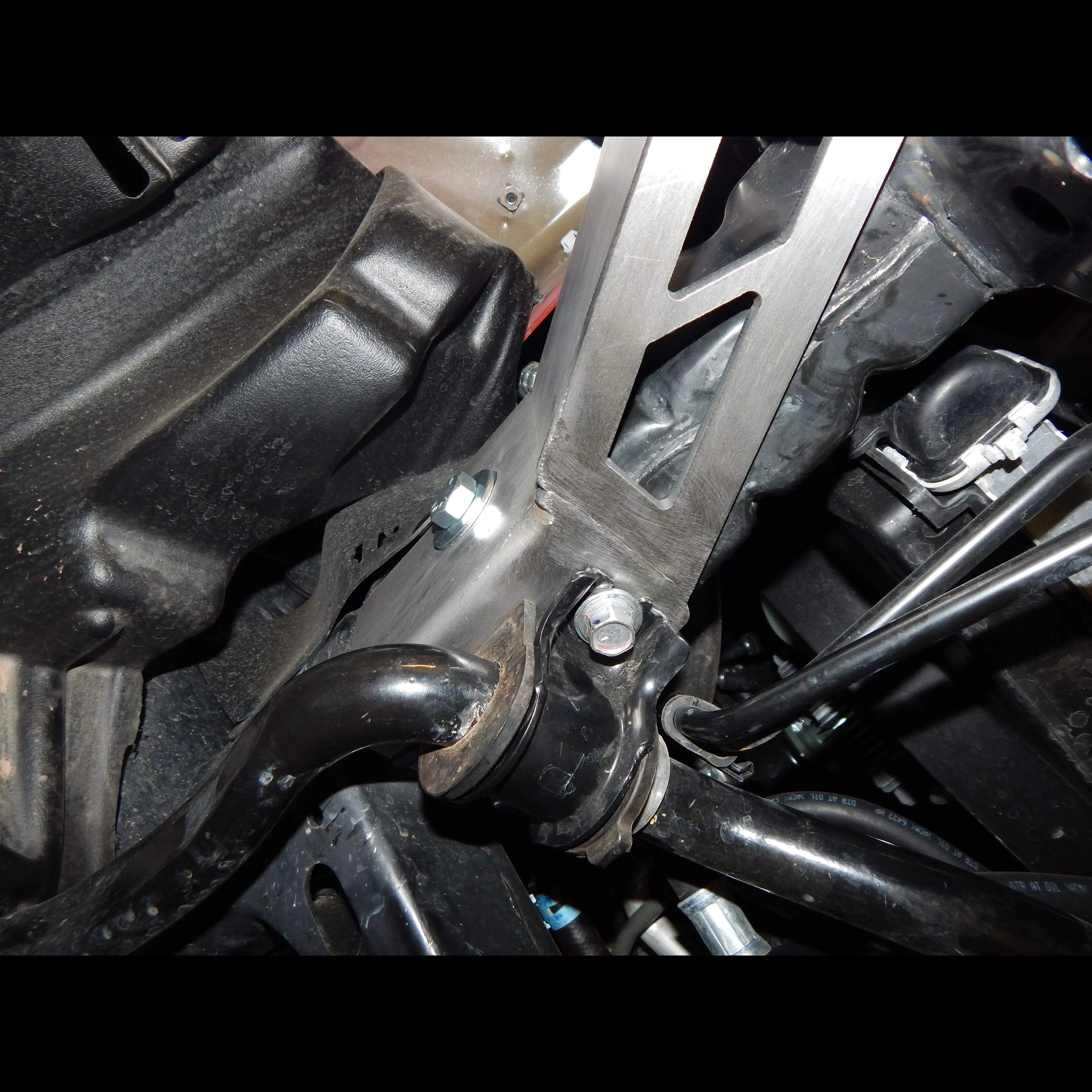 Steel front bumper frame support bracket installed on Toyota Tacoma chassis