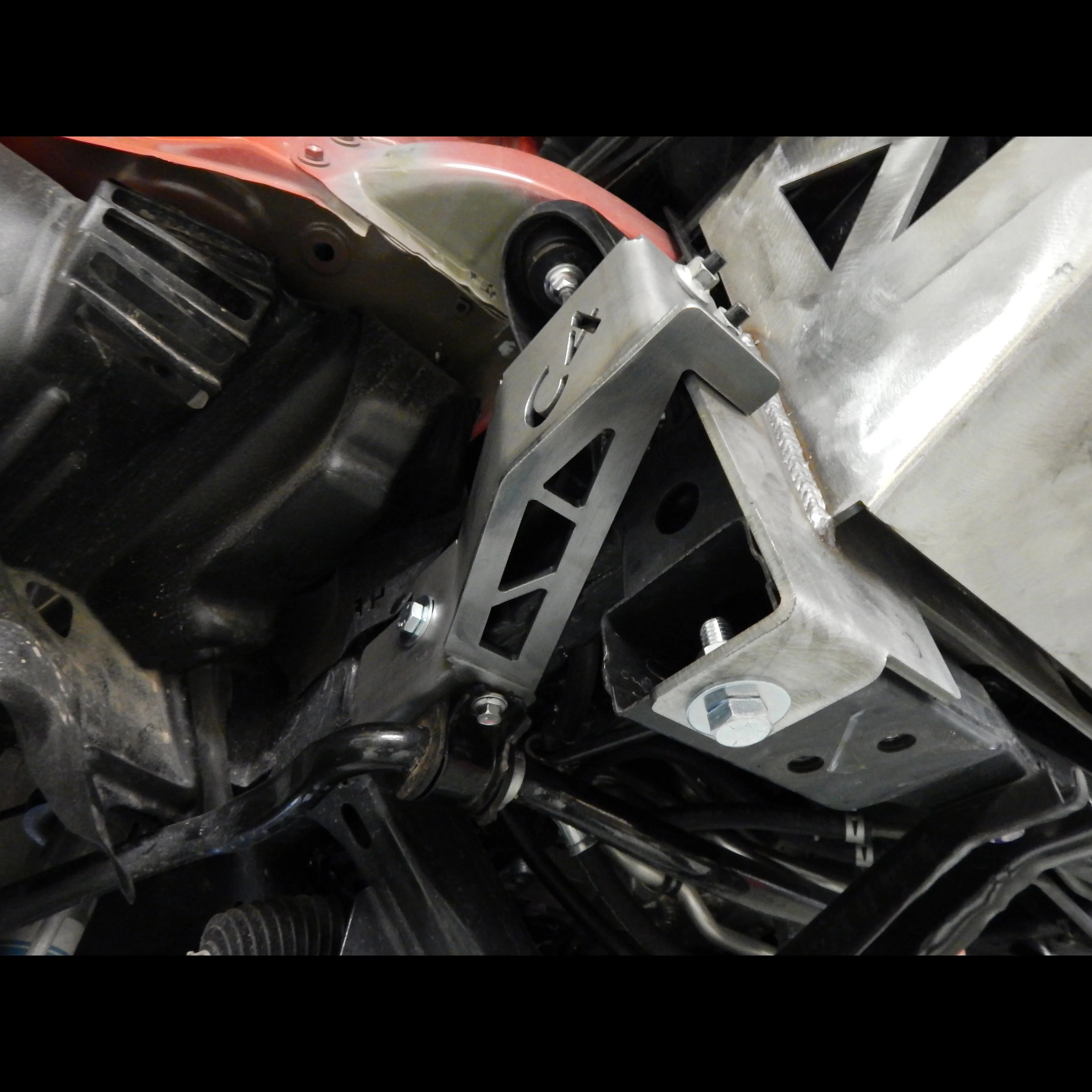 Toyota Tacoma front bumper frame support bracket installed, steel construction, off-road accessory
