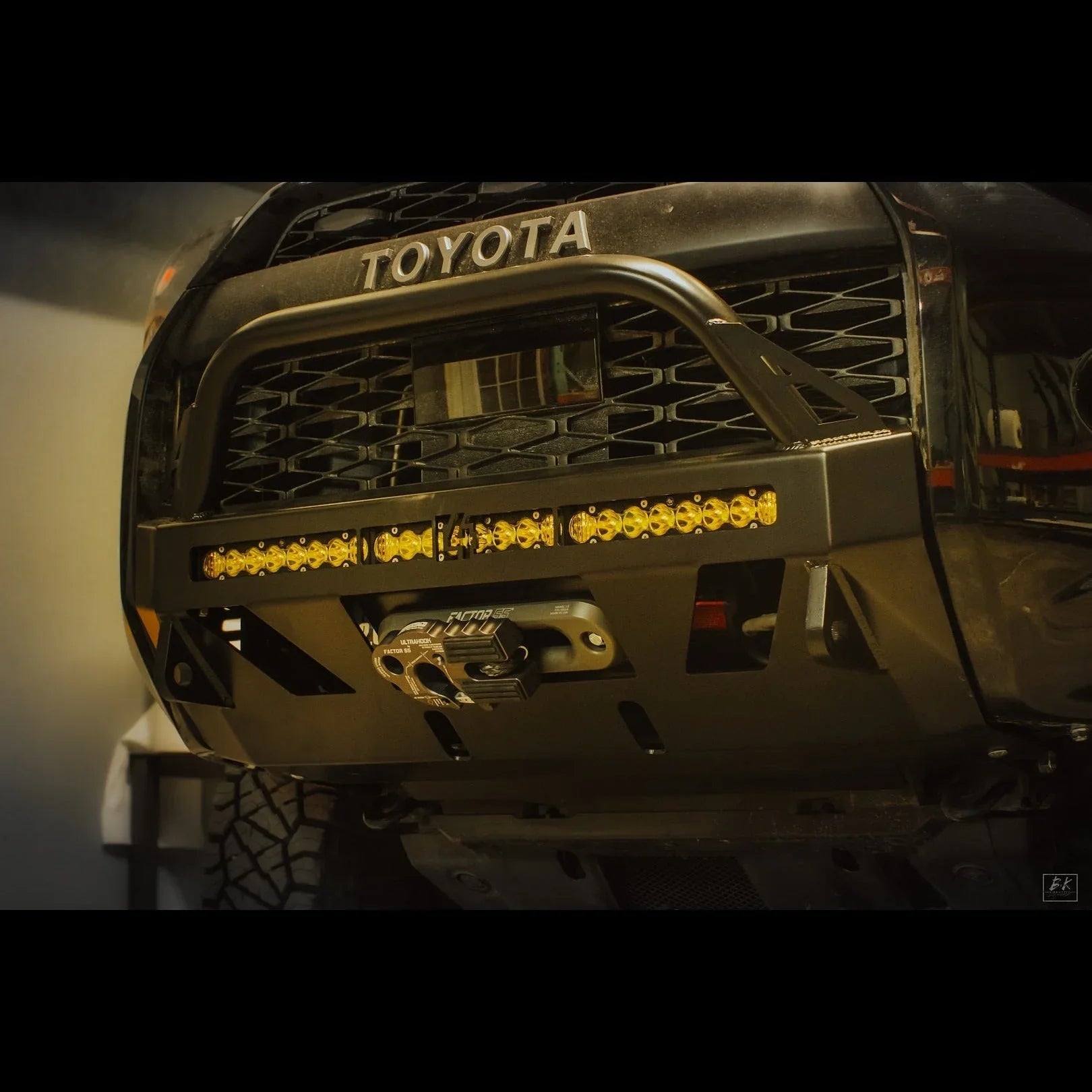 Toyota 4Runner front bumper with winch and LED light bar, off-road vehicle accessory