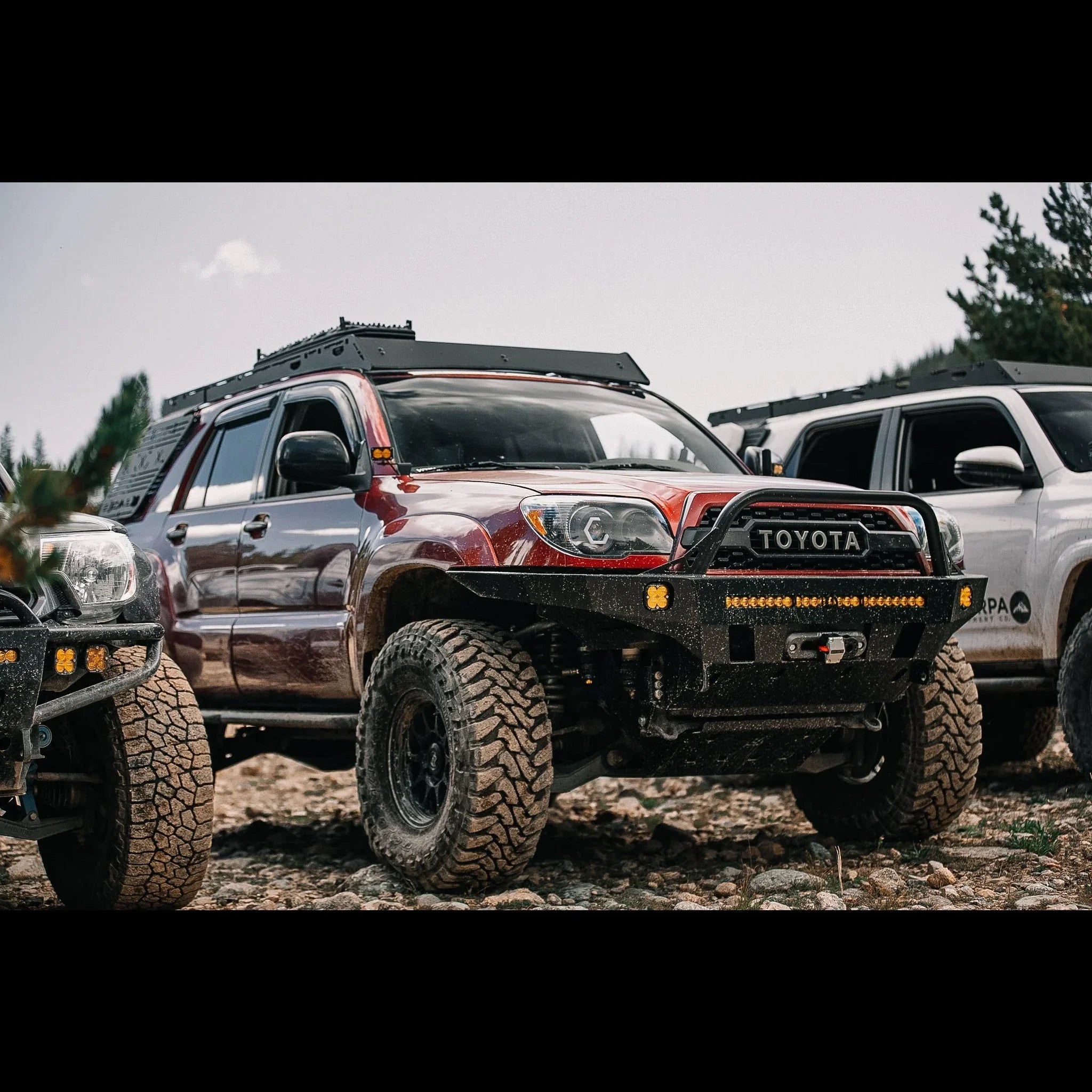 Toyota 4Runner overland SUV with roof rack, off-road tires, and steel front bumper outdoors