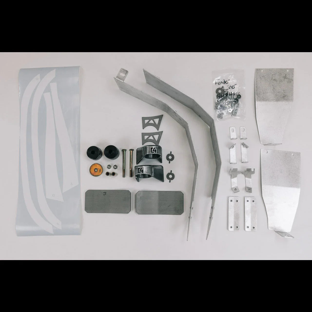 Overland fender armor kit with metal brackets, mounting hardware, and protective decals