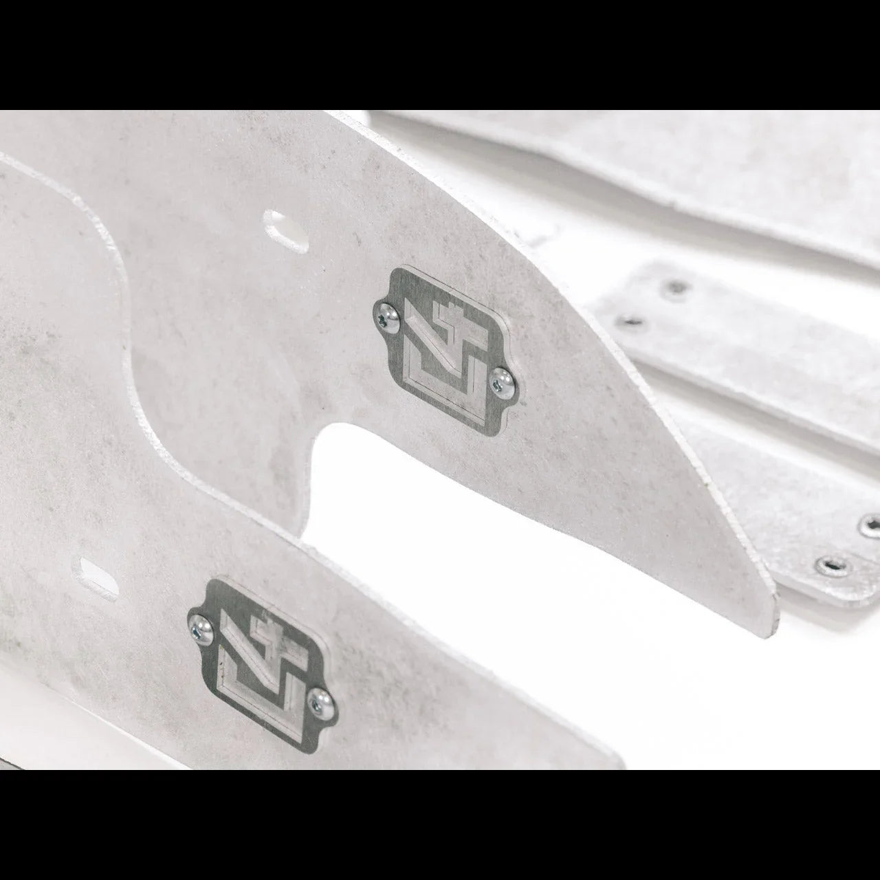 Close-up of aluminum vehicle skid plates with logo, overland off-road accessory parts