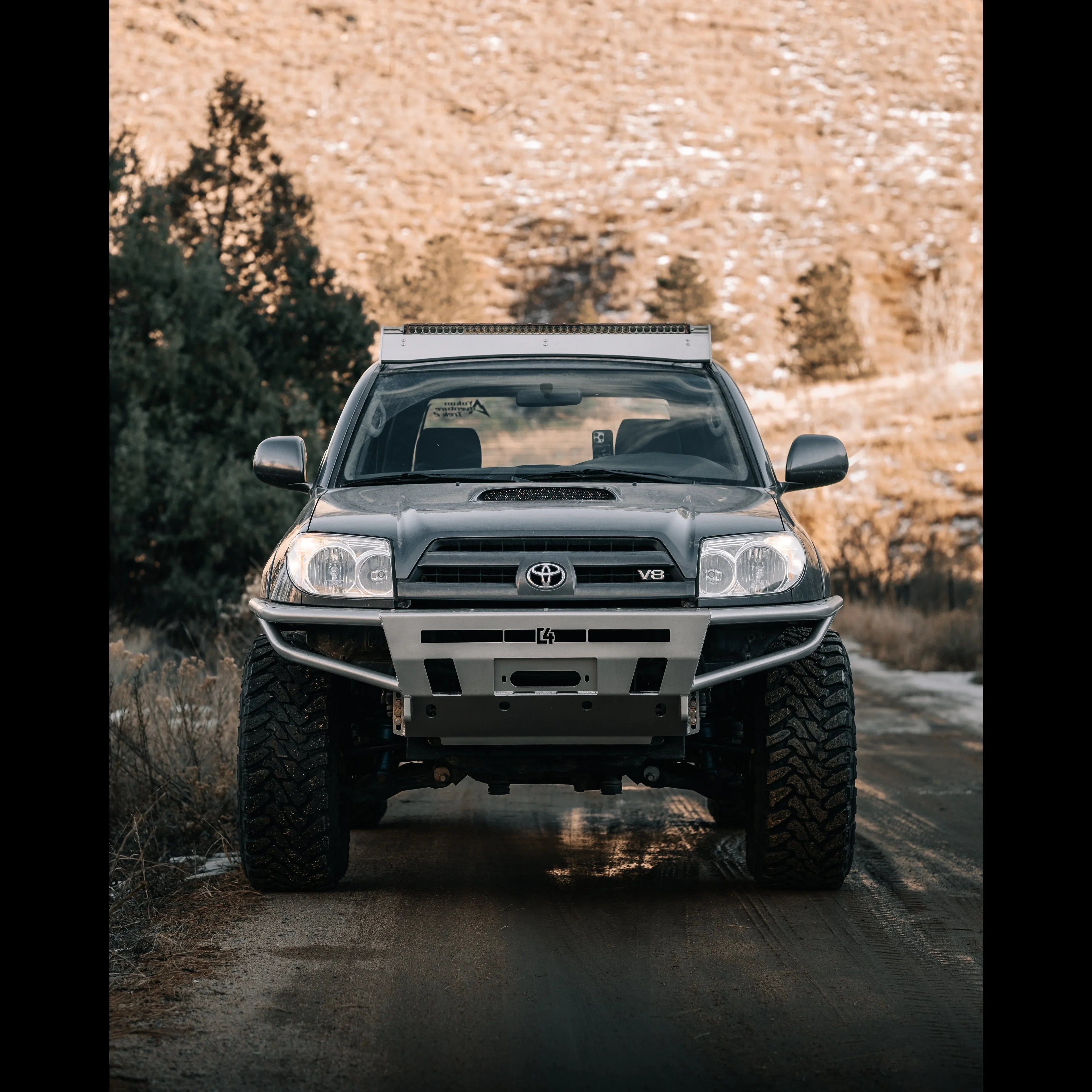 Toyota 4Runner V8 with off-road bumper and LED light bar on rugged trail