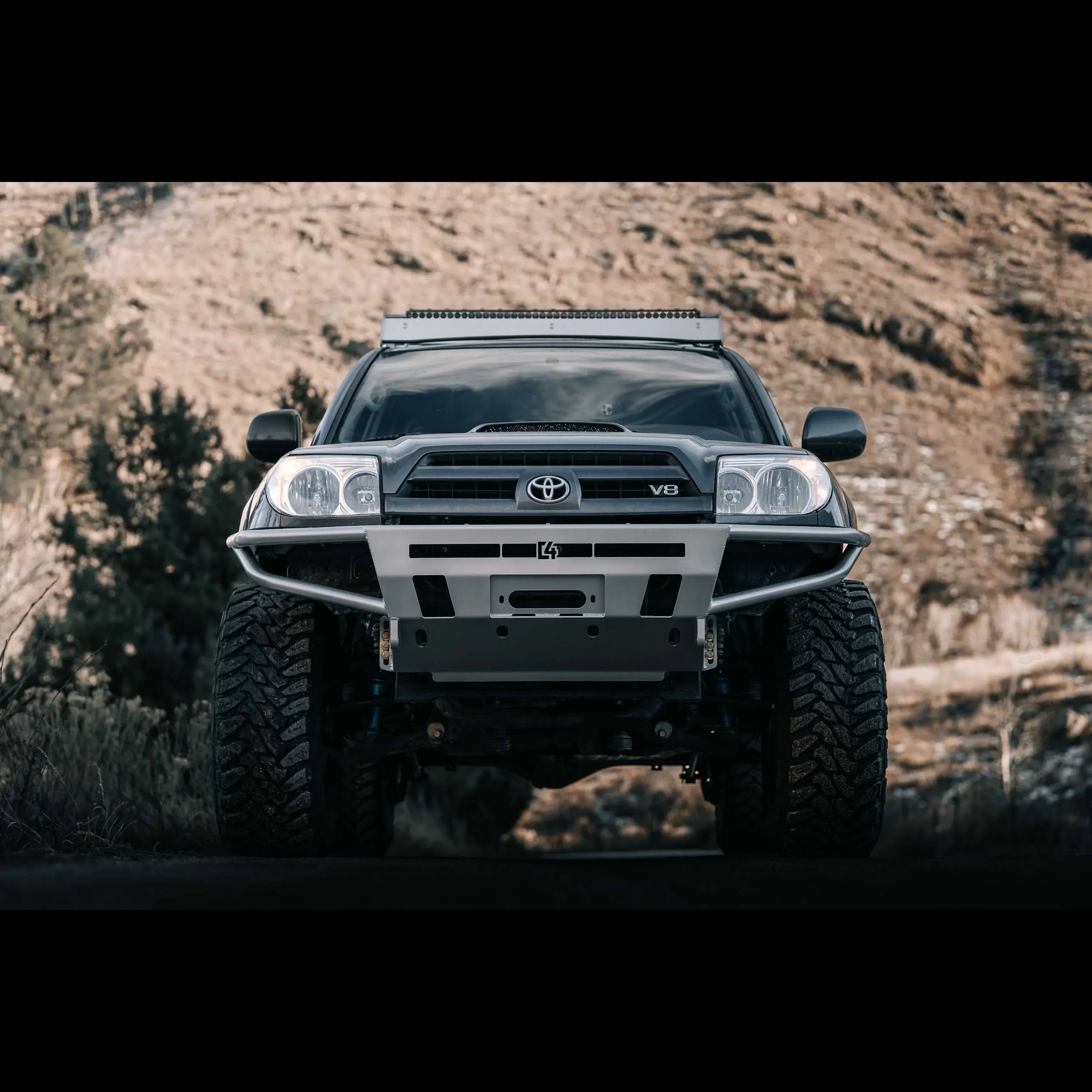 Toyota 4Runner with off-road front bumper and rugged tires parked outdoors