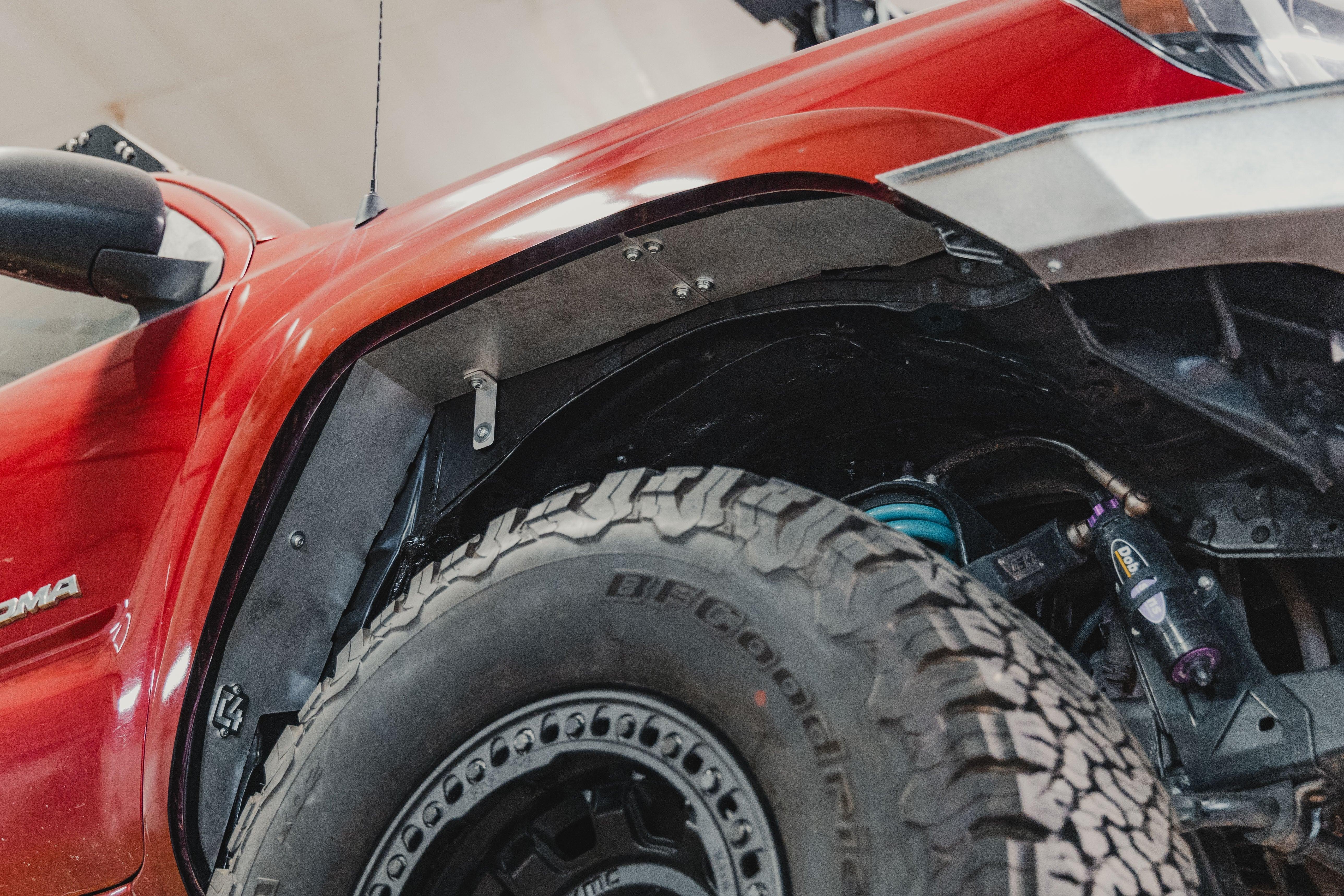 Toyota Tacoma front fender with off-road tire, upgraded suspension, and inner fender liner