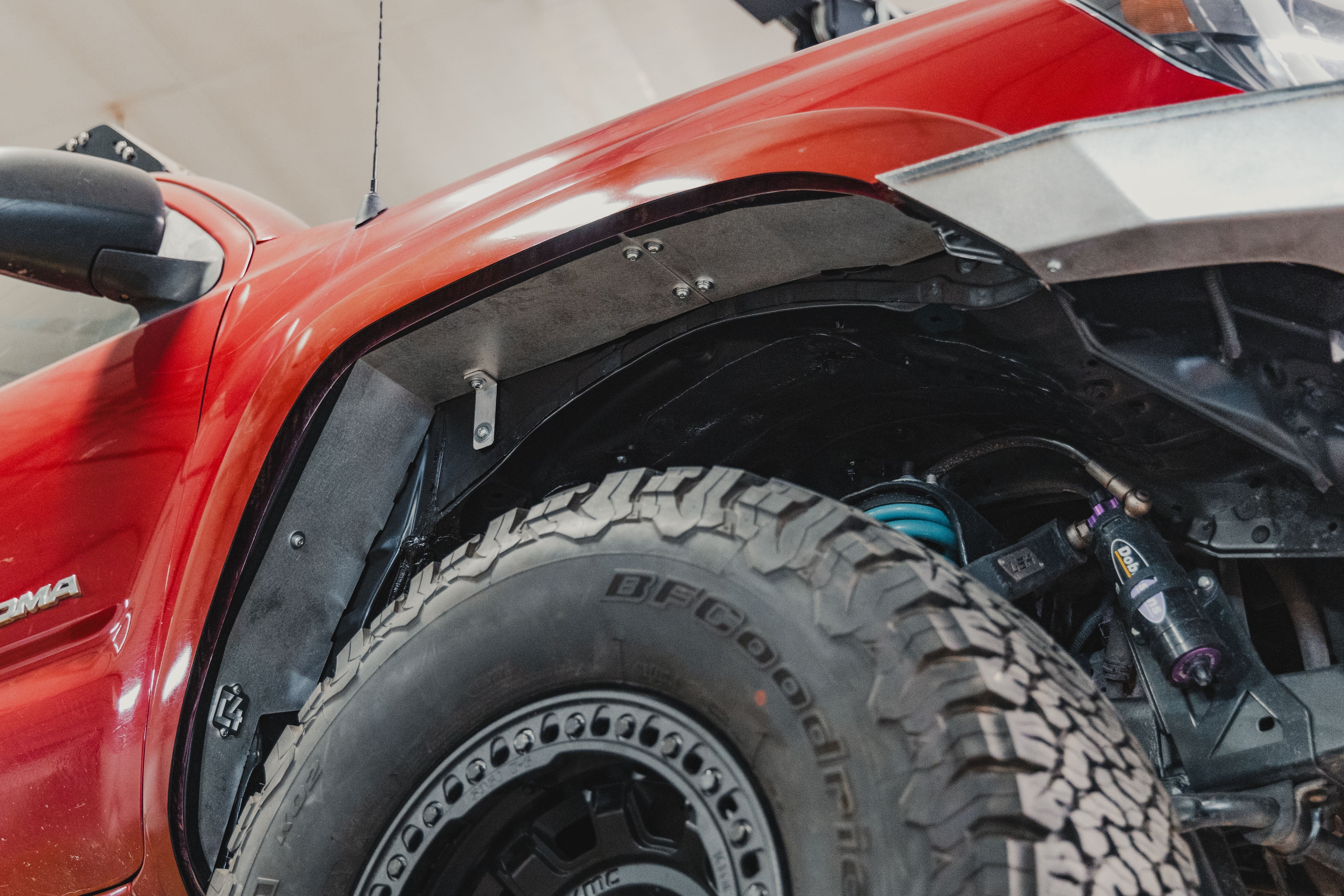 Toyota Tacoma with off-road fender liner, suspension, and all-terrain BFGoodrich tire