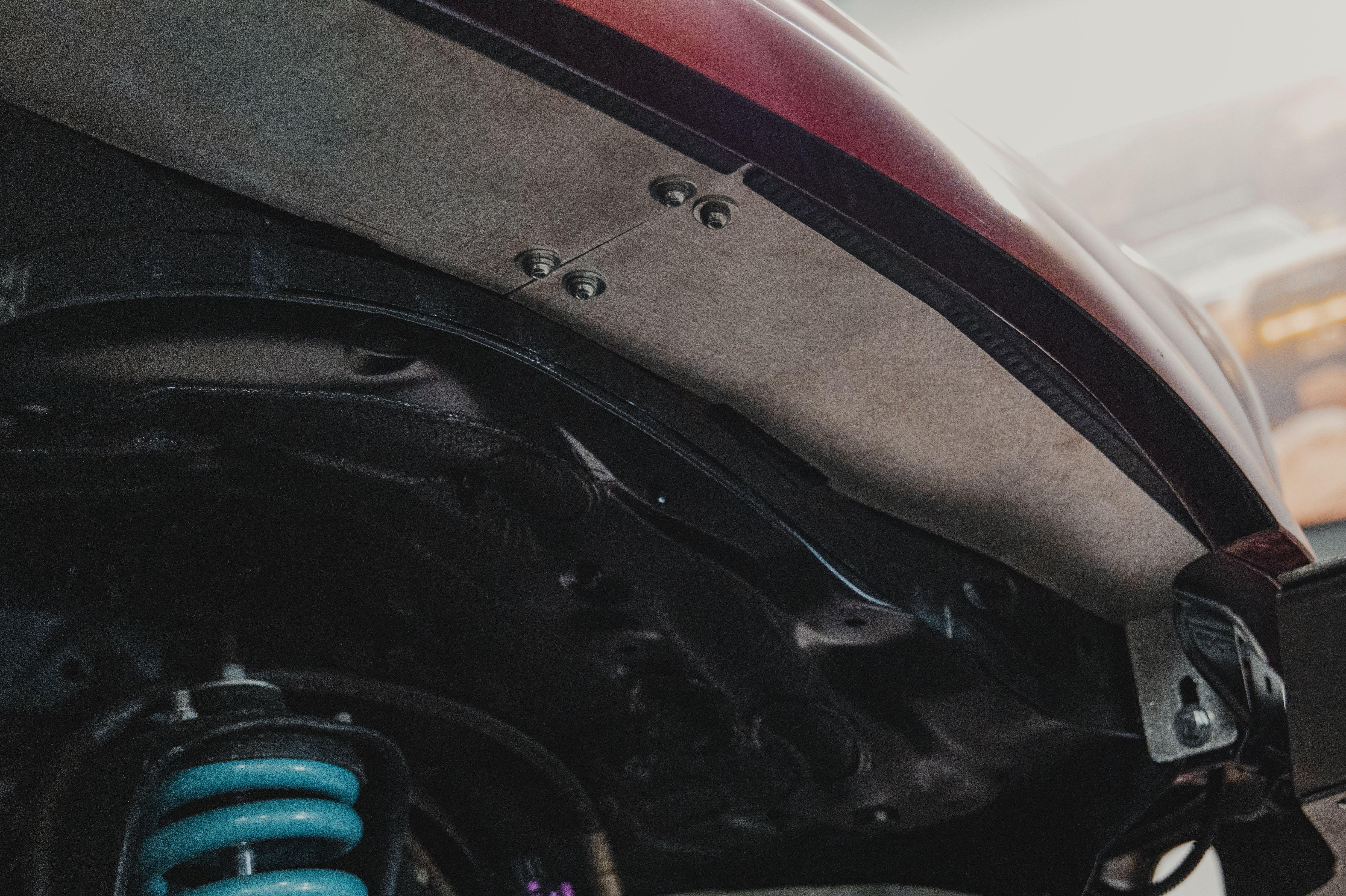 Close-up of aluminum fender liner installed on off-road vehicle wheel well