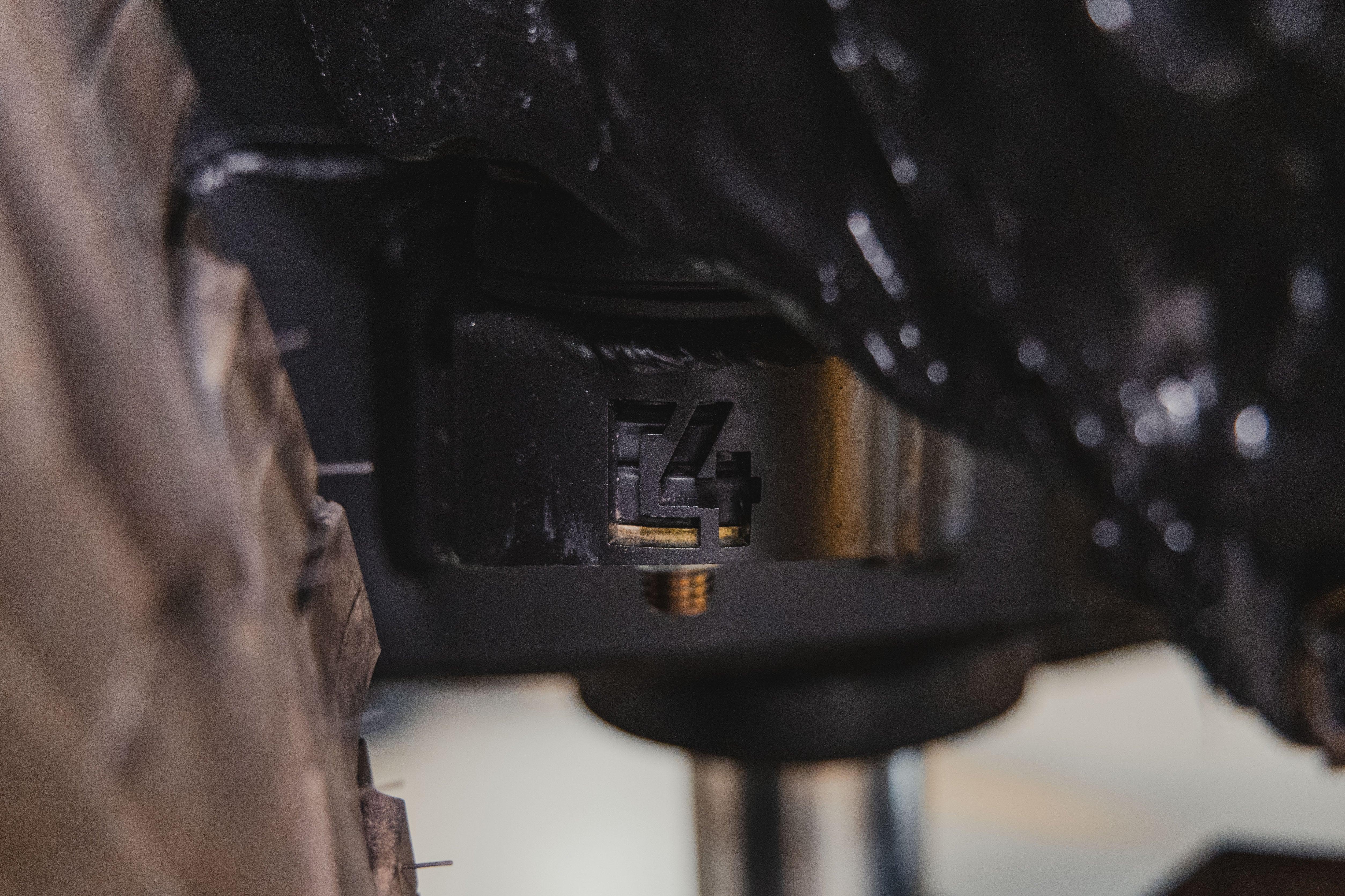 Close-up of an off-road vehicle suspension component with C4 logo, suitable for Toyota Tacoma or similar overlanding trucks.
