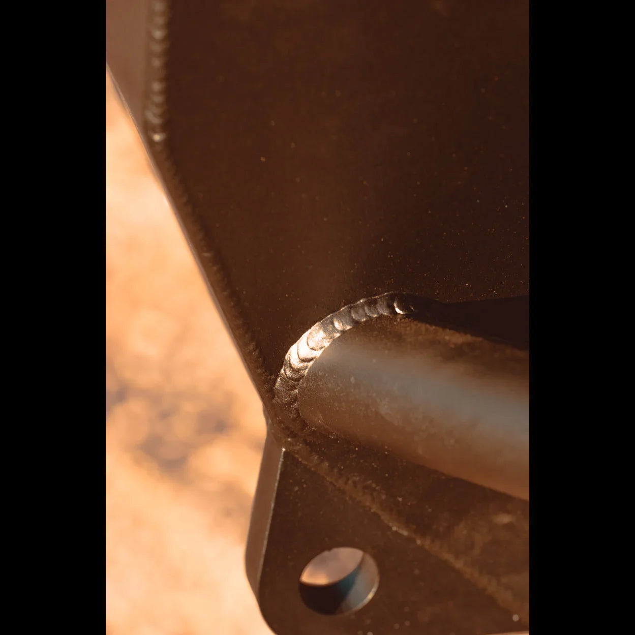 Close-up of welded metal vehicle accessory part with mounting hole, for off-road trucks and SUVs