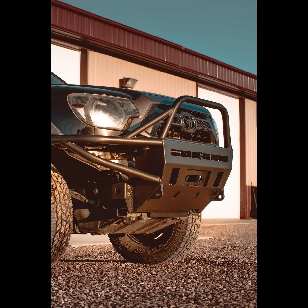 Off-road steel front bumper on Toyota Tacoma, rugged overland vehicle accessory