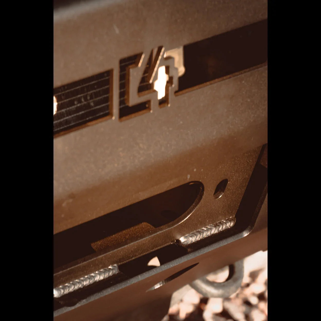 Close-up of heavy-duty off-road steel bumper with cutout and welds, suitable for overlanding vehicles