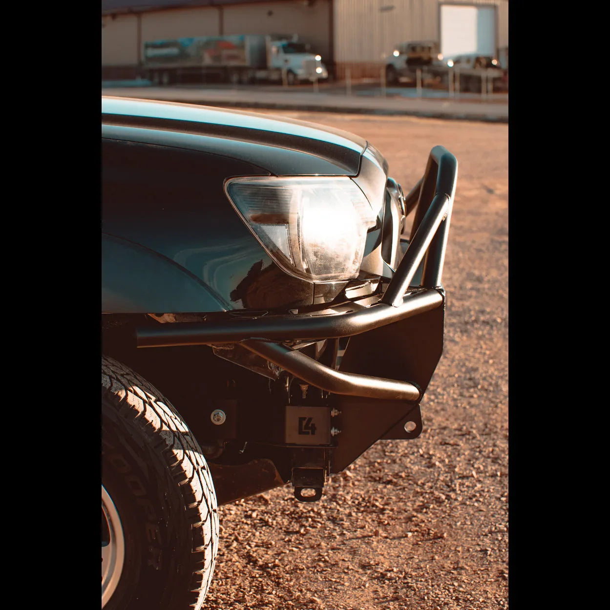 Toyota Tacoma front bumper steel off-road upgrade with grille guard and rugged tire outdoors