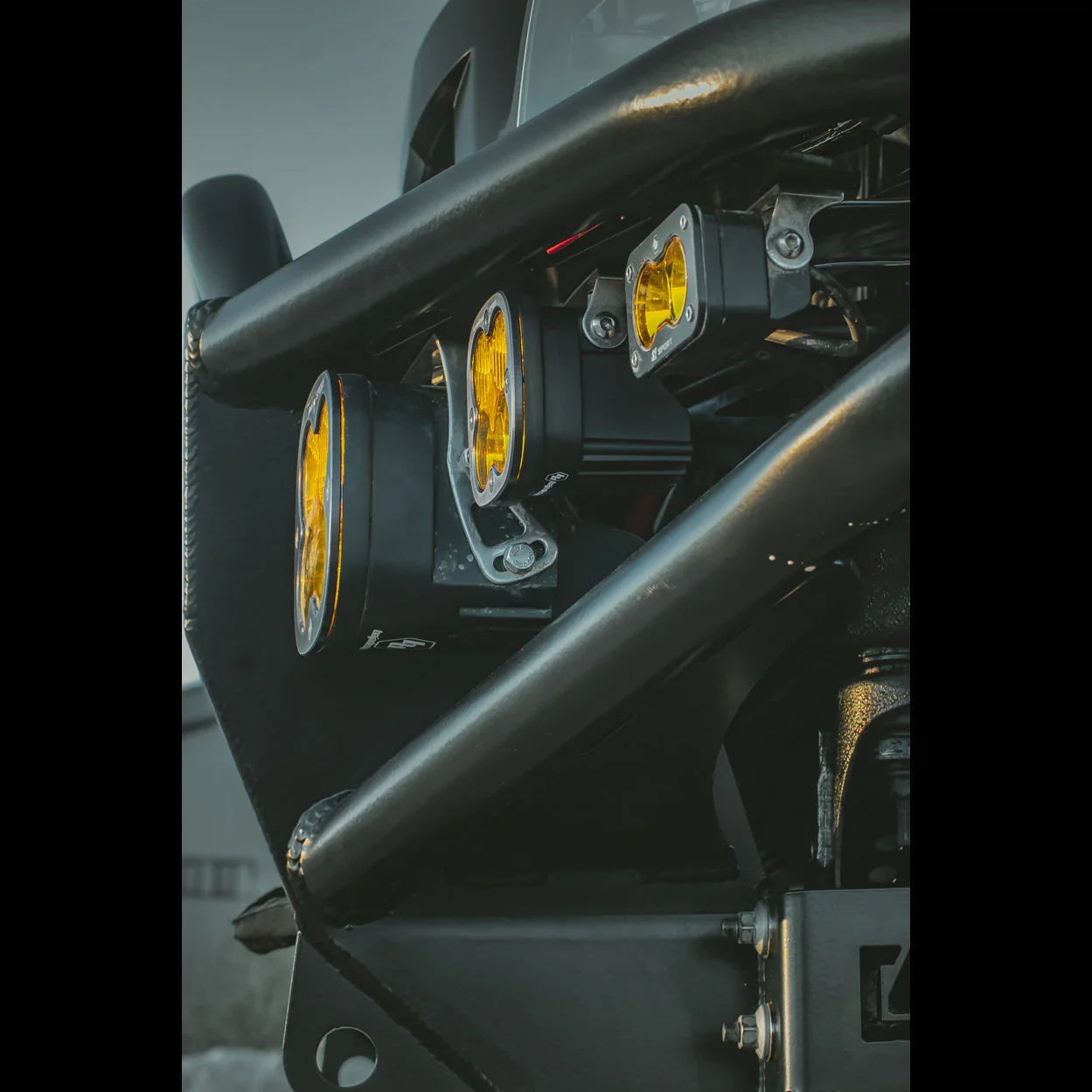 Close-up of off-road bumper with mounted yellow LED pod lights on a vehicle
