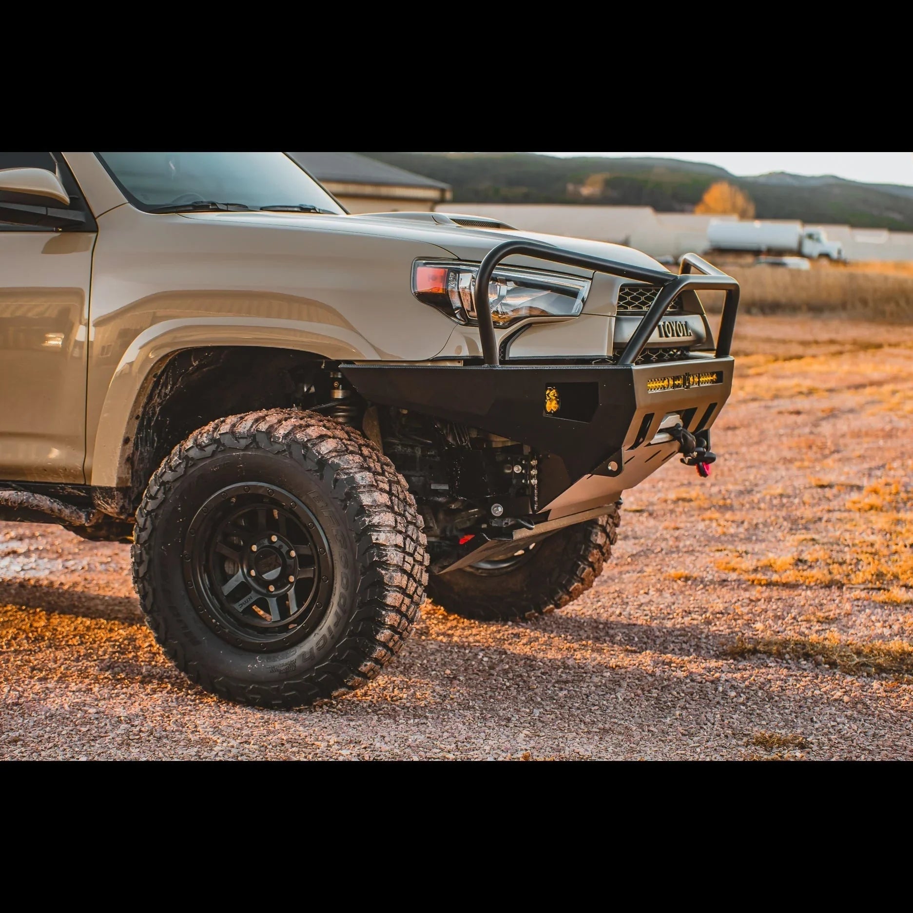 Toyota 4Runner with heavy duty overland front bumper and off-road tires on gravel