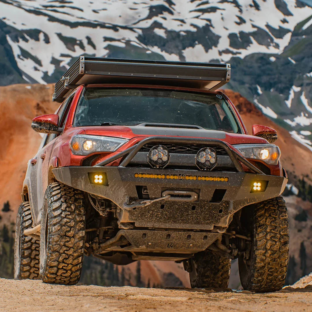 Toyota 4Runner with overland front bumper, off-road lights, mountain background