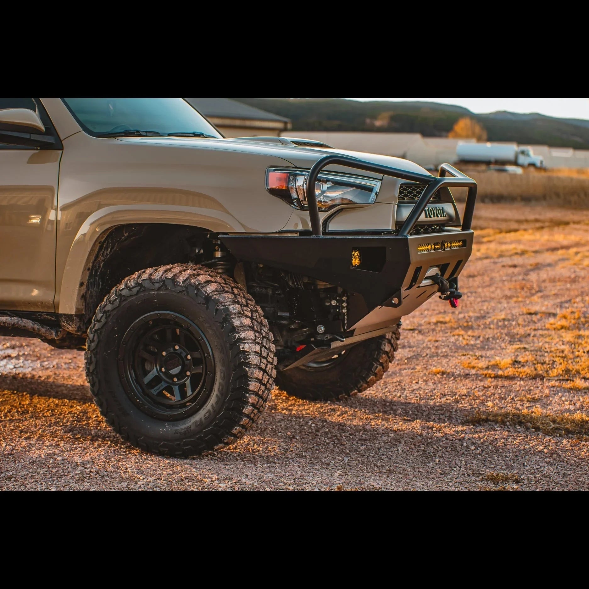 Toyota 4Runner with off-road front bumper, rock guard, winch mount, and rugged tires outdoors