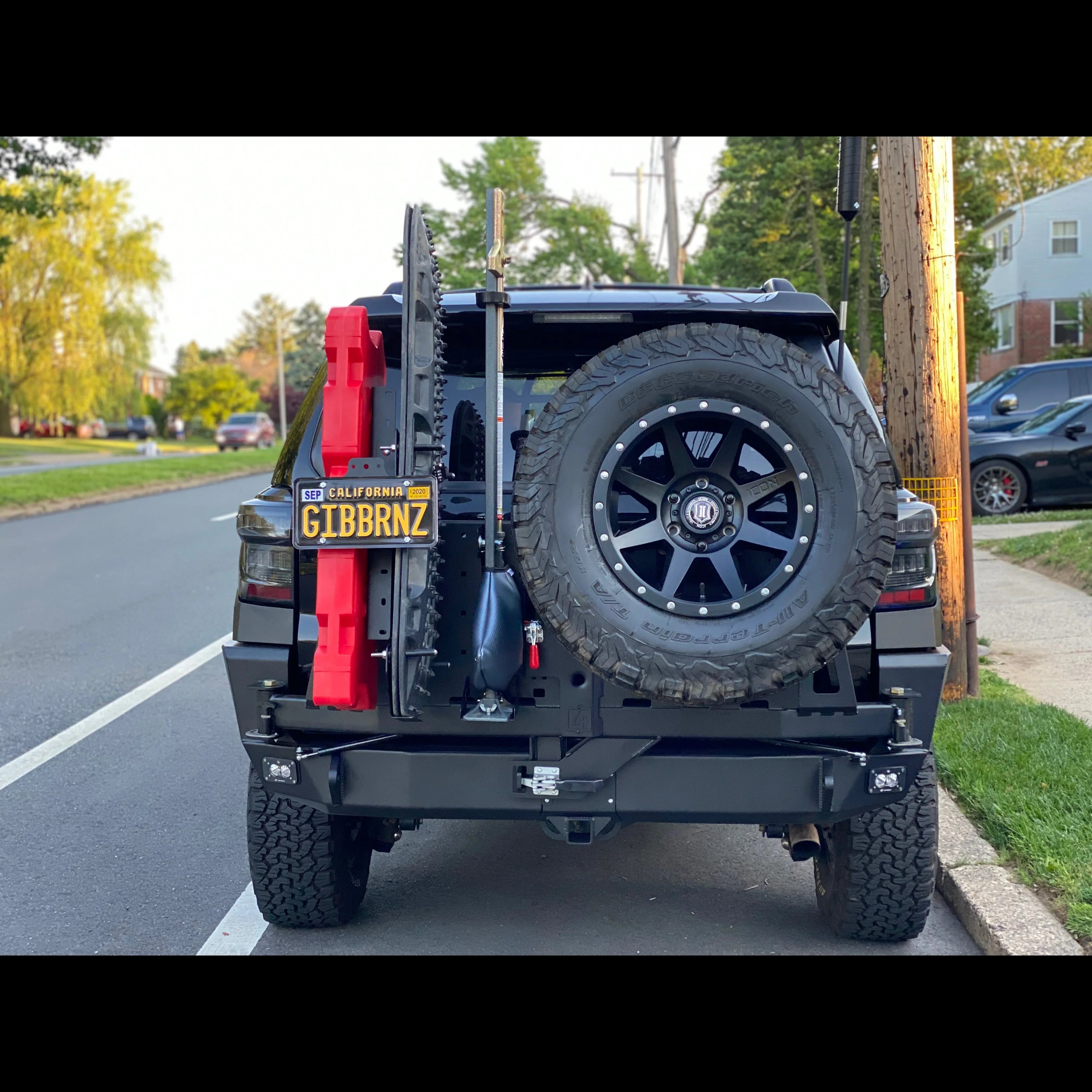 Toyota 4Runner with overland rear bumper, spare tire, recovery gear, and off-road accessories