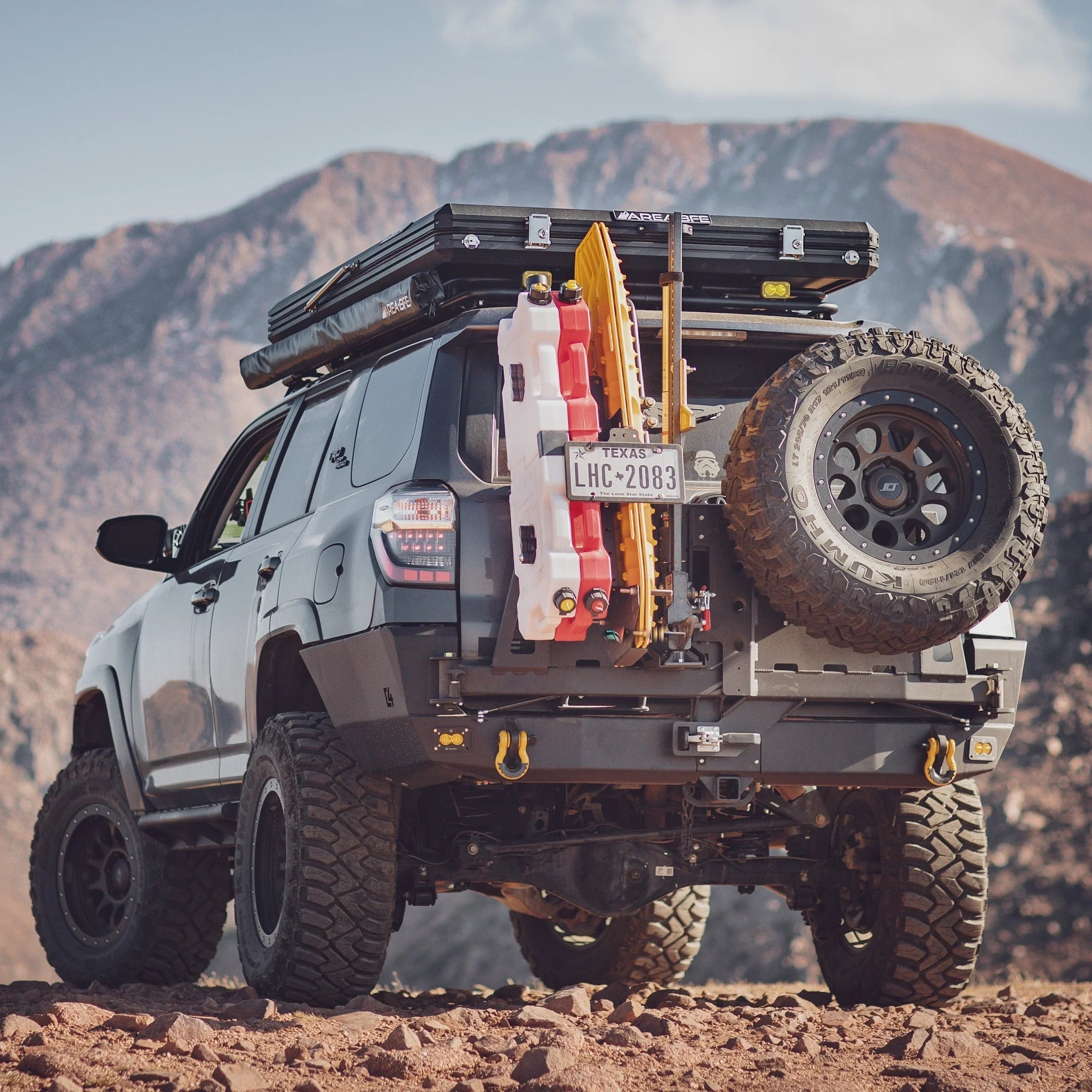 Toyota 4Runner with overland rear bumper, off-road gear, spare tire, and recovery tools
