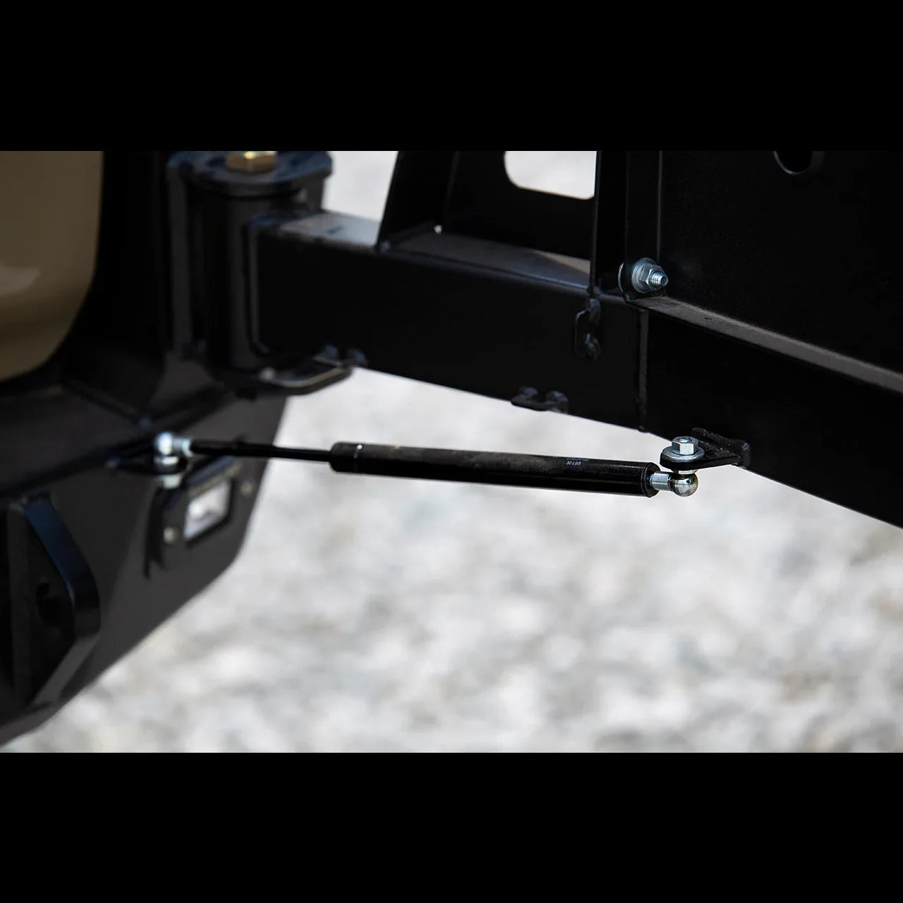Close-up of rear bumper strut on Toyota 4Runner overland series, black metal hardware