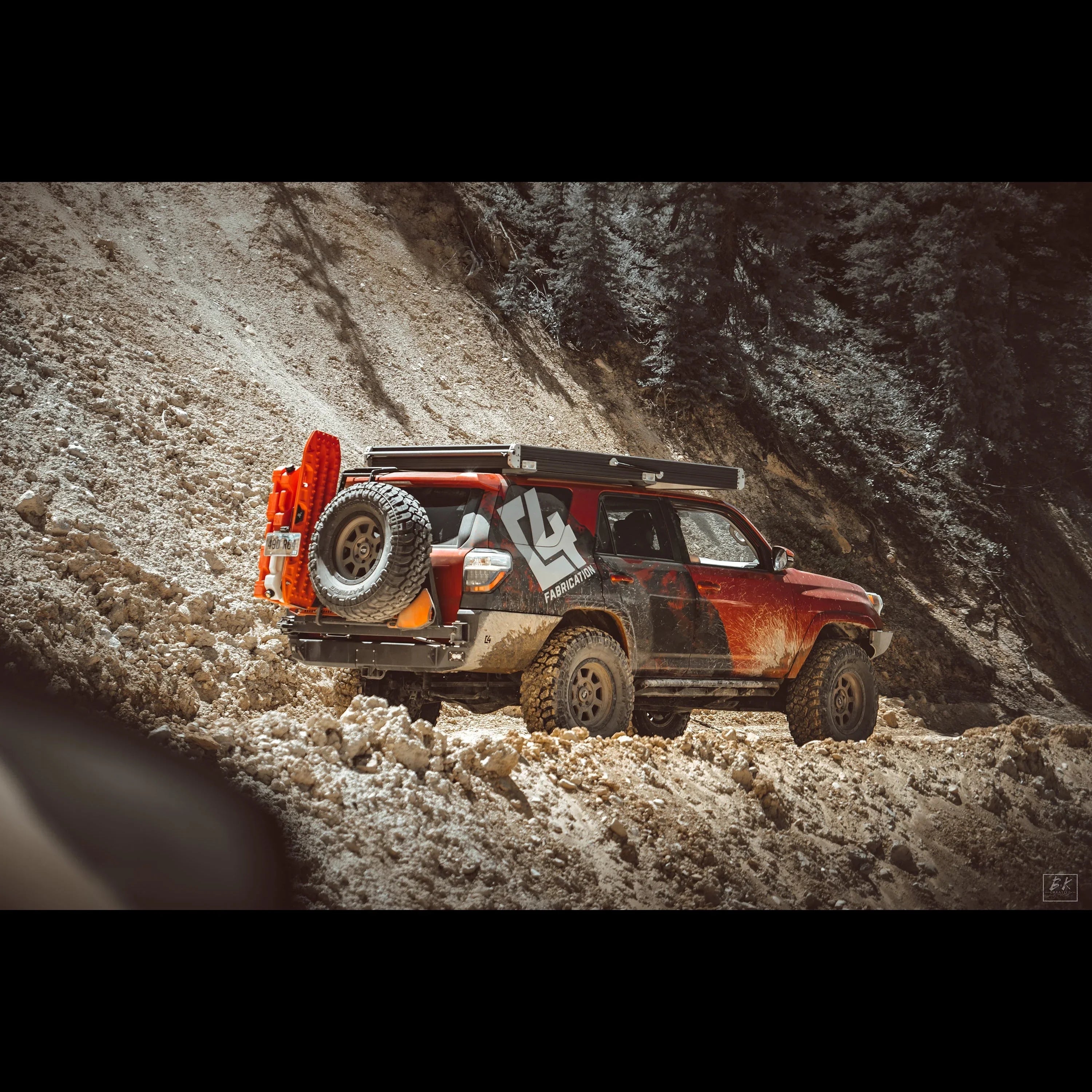 Toyota 4Runner with overland rear bumper, spare tire, off-road accessories on mountain trail
