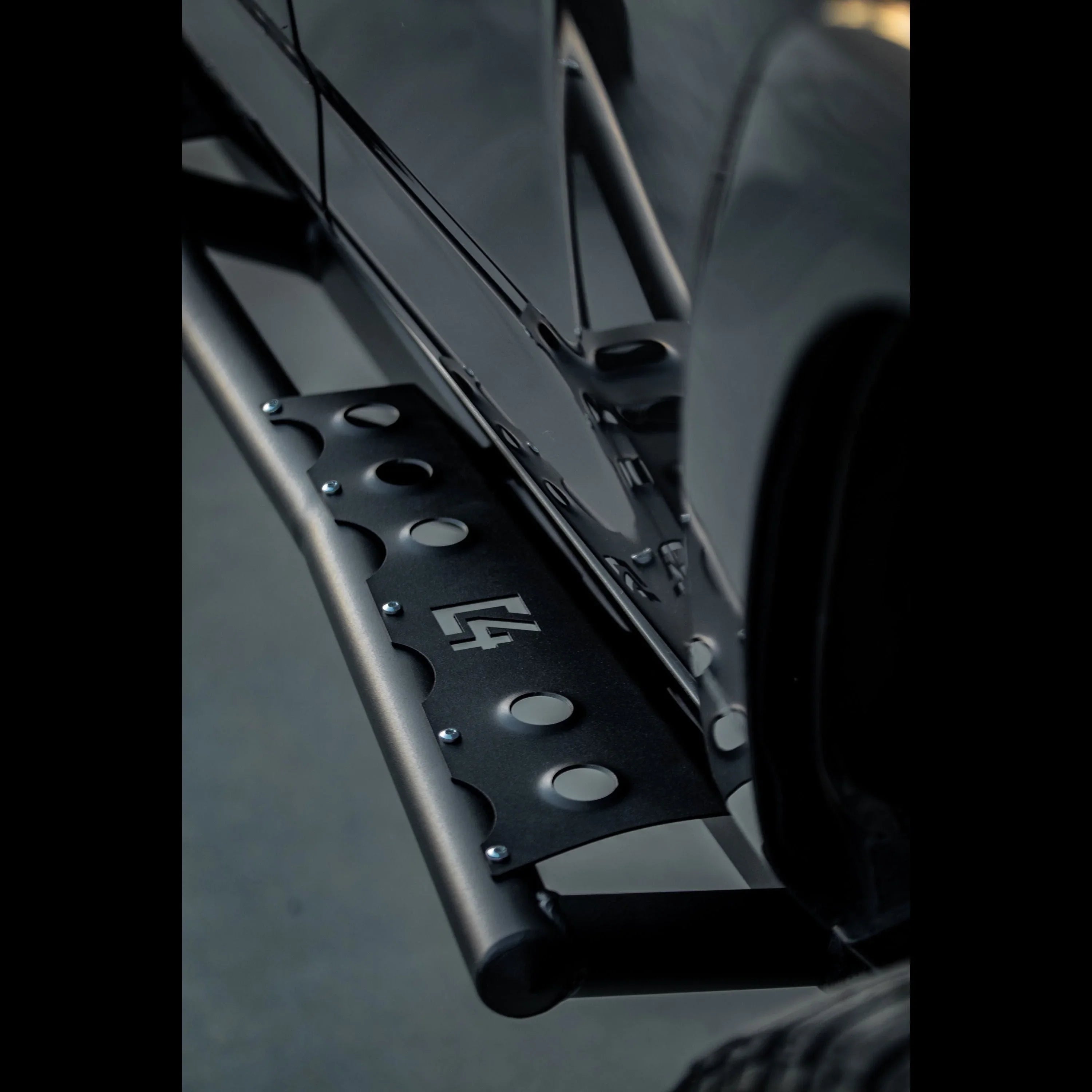 Close-up of black rock slider step for Toyota 4Runner 5th Gen vehicle, off-road accessory