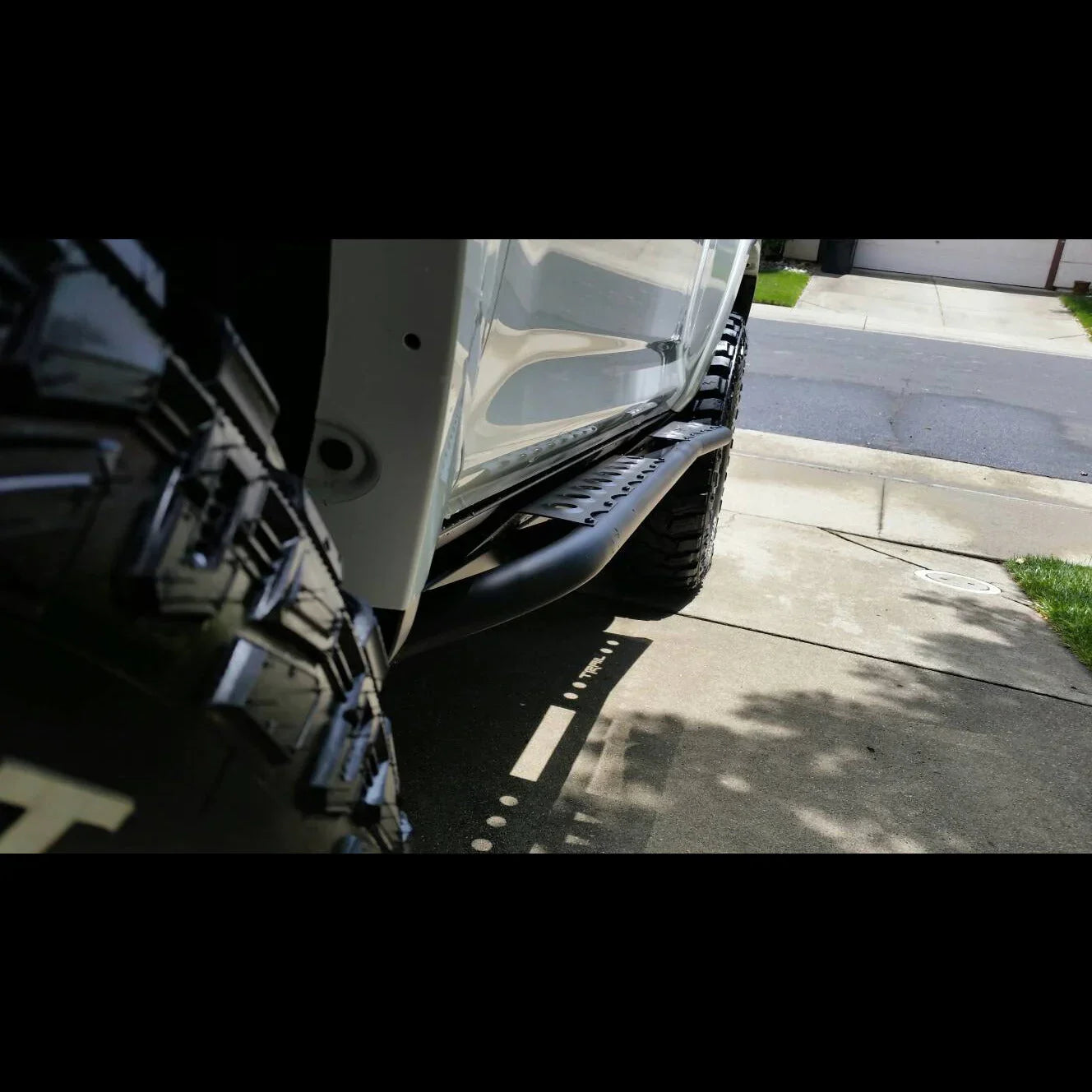 Closeup of off-road rock sliders installed on a Toyota 4Runner 5th Gen.