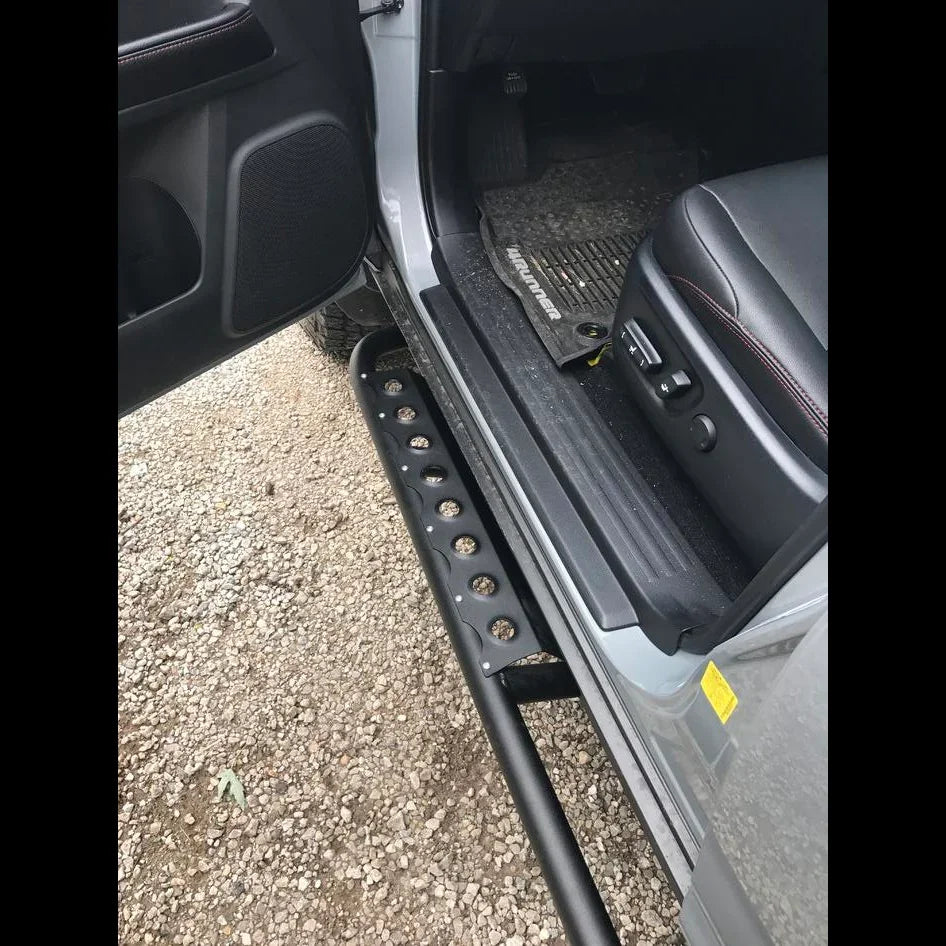 Toyota 4Runner 5th Gen rock slider step bar installed, vehicle door open, interior visible